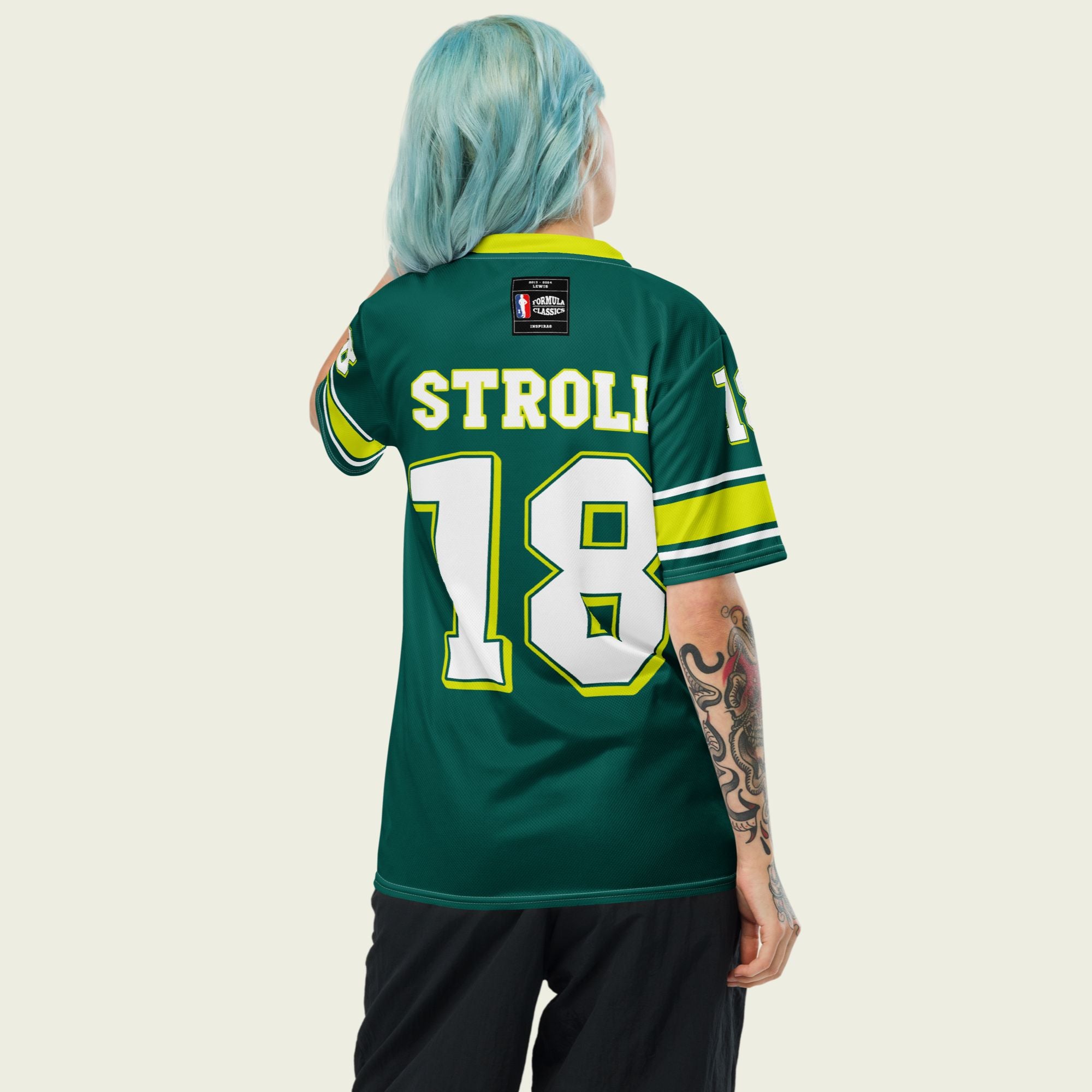 A british green and highlight yellow football jersey with Lance Stroll's Aston Martin F1 racing number 18 on the front and back. It has the name Stroll on the front and back as well in white with a yellow outline.