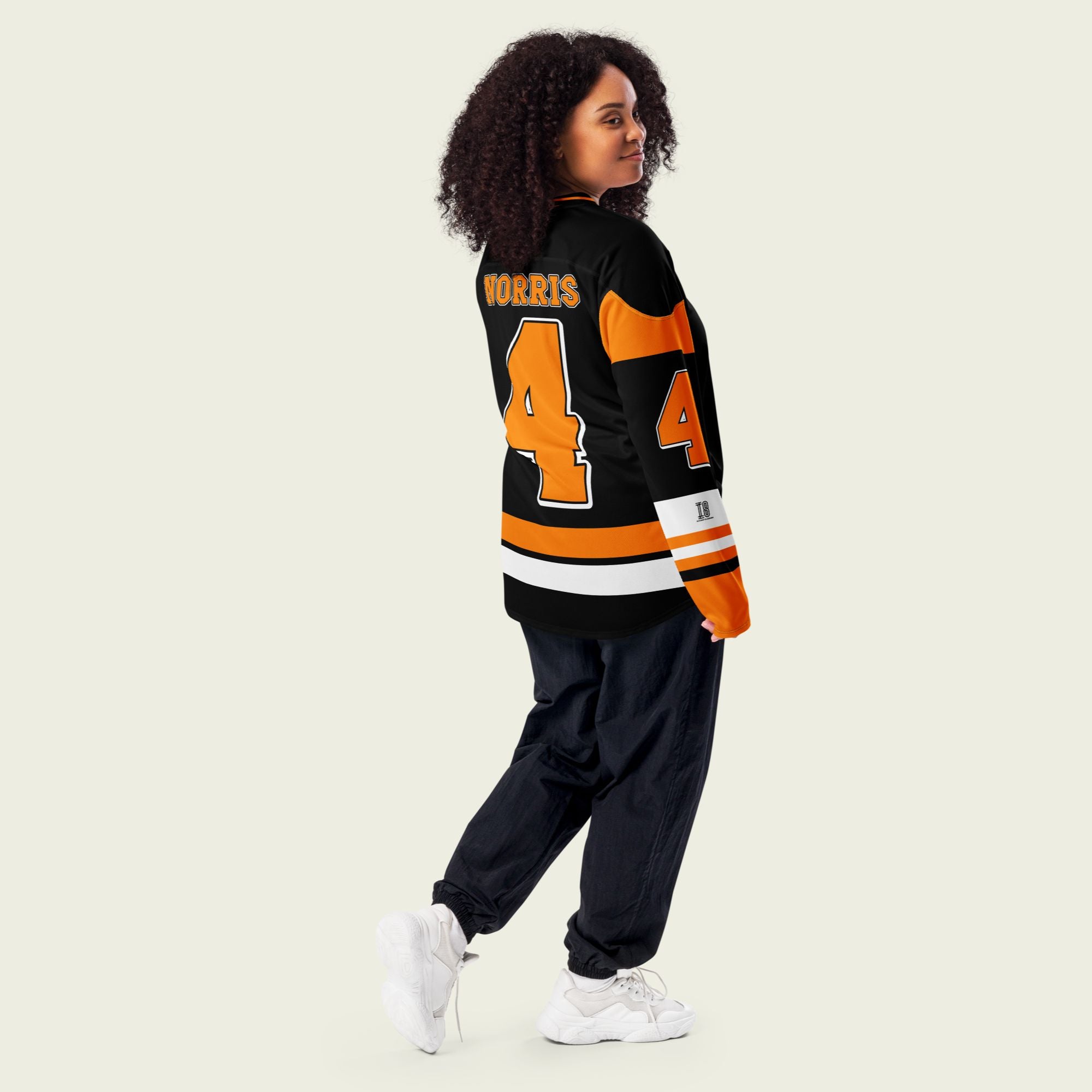 A black hockey jersey with Lando Norris mclaren F1 racing number 4 on the front and back in papaya orange, also the name norris is on the back and front in orange