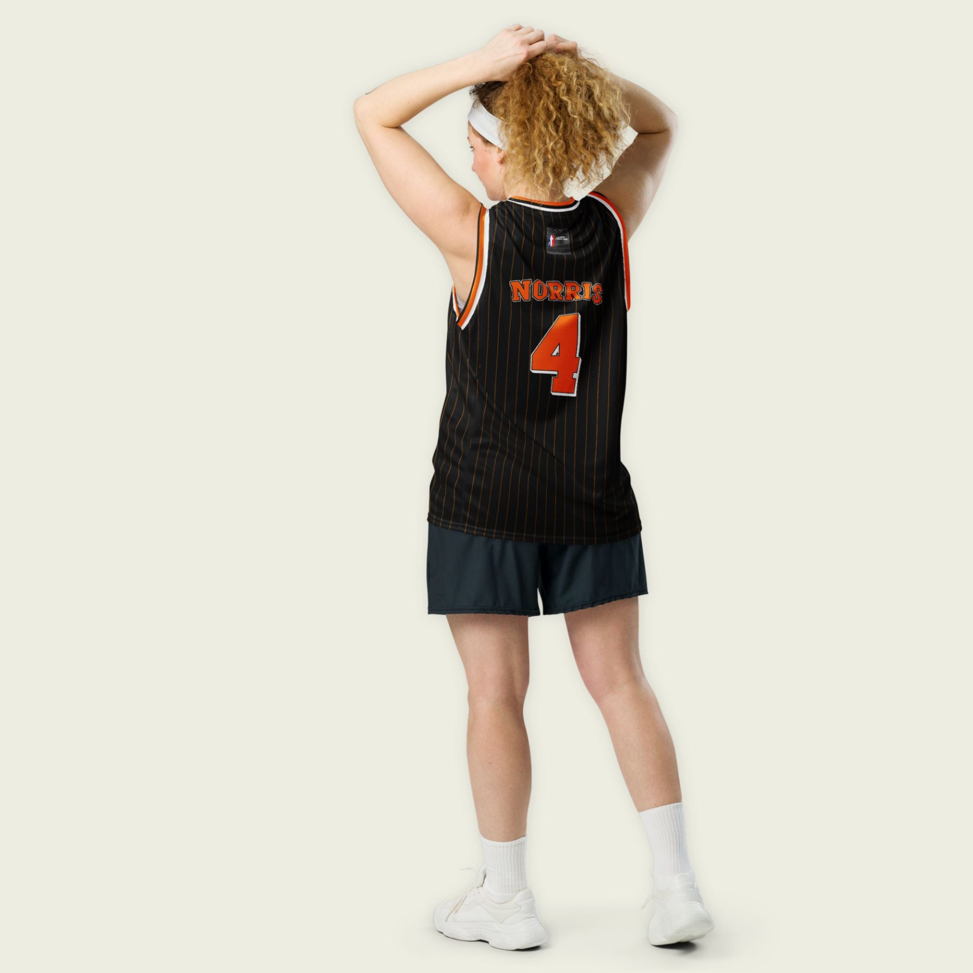 A black and papaya orange pin striped basketball Jersey with Lando Norris's McLaren F1 racing number 4 in orange on the front and back.