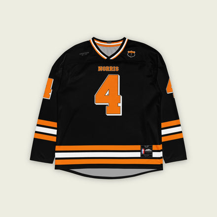 A black hockey jersey with lando norris's mclaren F1 racing number 4 on the front and the black. it has oragne stripesin the top, bottom, and arms. WIth his last name norris on the front and back.