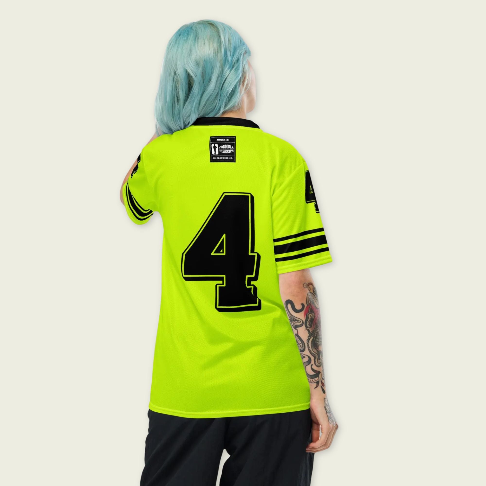 A neon green and black football jersey with Lando Norris's McLaren F1 racing number 4 on the back and front in black. It has the name Norris in black on the front and back as well.