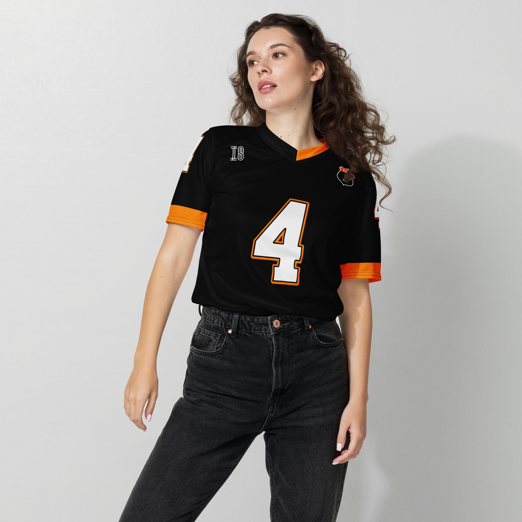 A black and papaya orange football jersey with Lando Norris's McLaren F1 racing number 4 on the back and front in white. It has the name Norris in orange on the front as well.