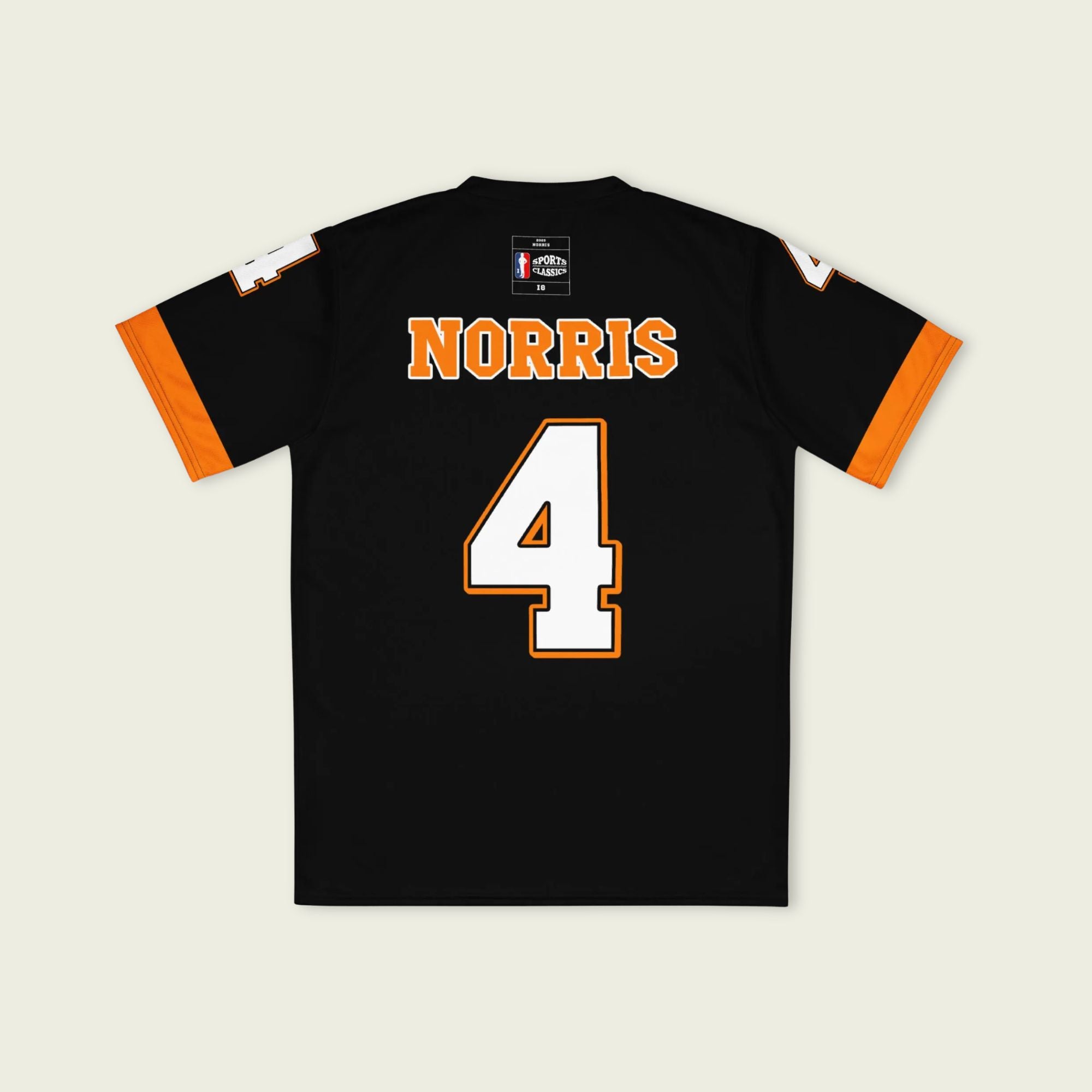 A black and papaya orange football jersey with Lando Norris's McLaren F1 racing number 4 on the back and front in white. It has the name Norris in orange on the front as well.