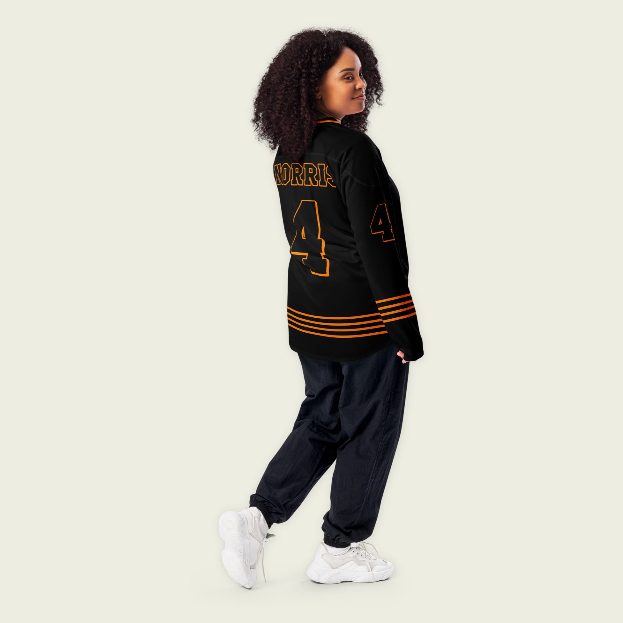 A black and papaya orange hockey jersey with orange stripes at the bottom, and Lando Norris's F1 racing number 4 on the front and back.
