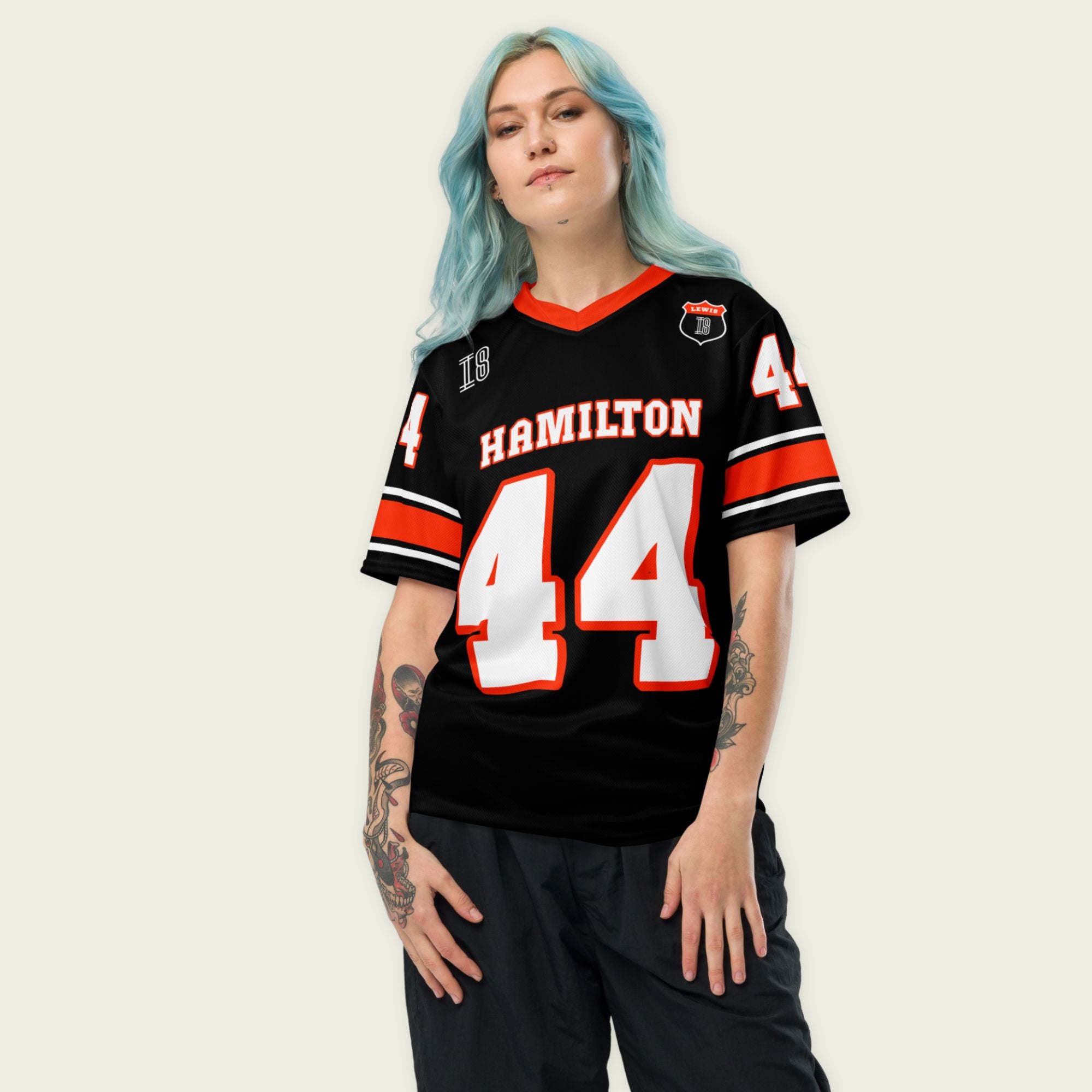 A black and red football jersey with Lewis Hamilton's Ferrari  F1 racing number 44 on the back and front in white. It has the name Hamilton in red on the front and back as well.