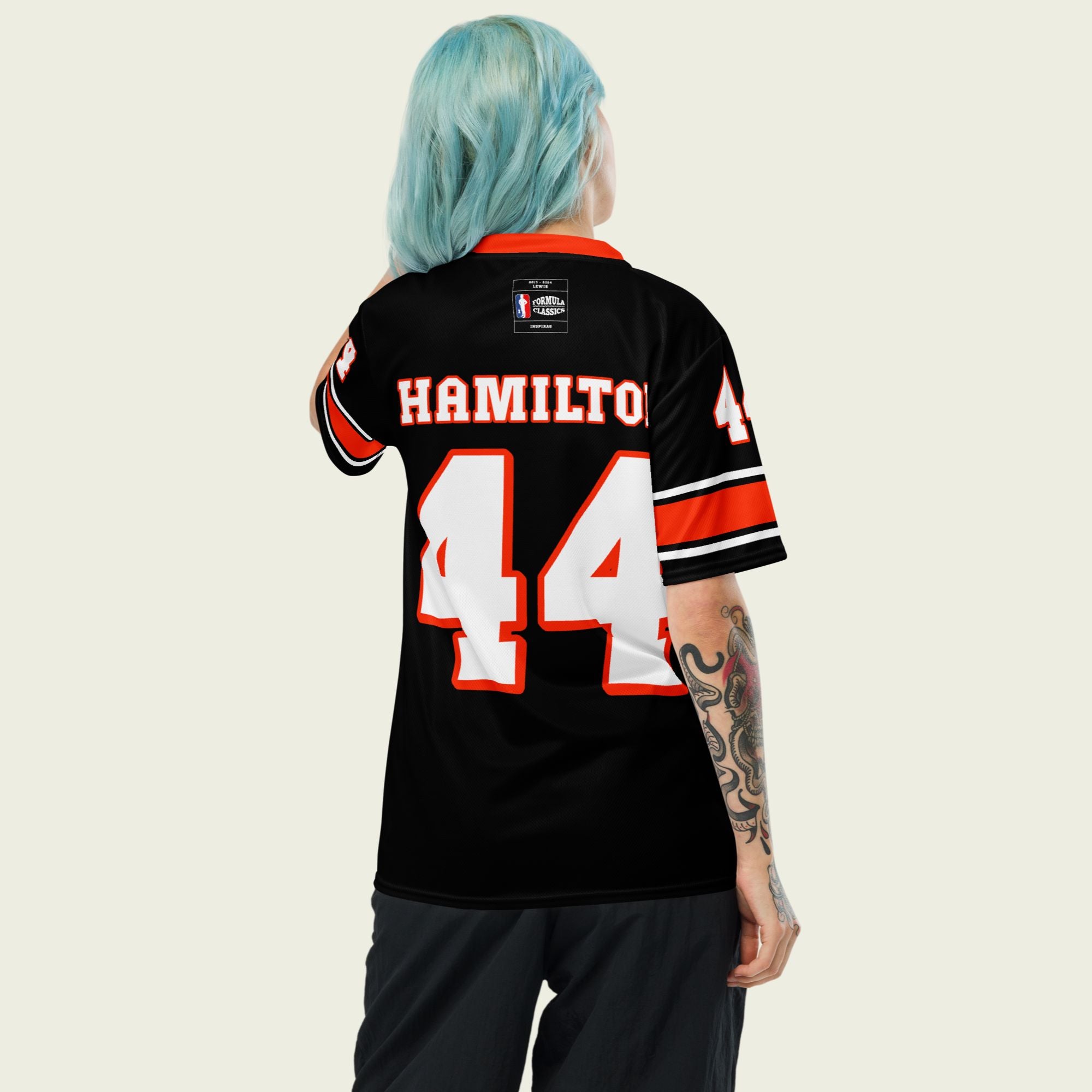 A black and red football jersey with Lewis Hamilton's Ferrari  F1 racing number 44 on the back and front in white. It has the name Hamilton in red on the front and back as well.