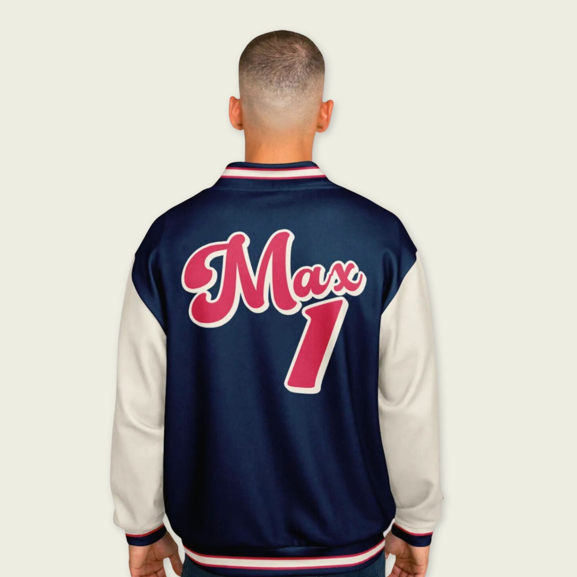 A navy blue, tan, and red varsity jacket with Max Verstappen Redbull F1 racing number in red on the front and back.