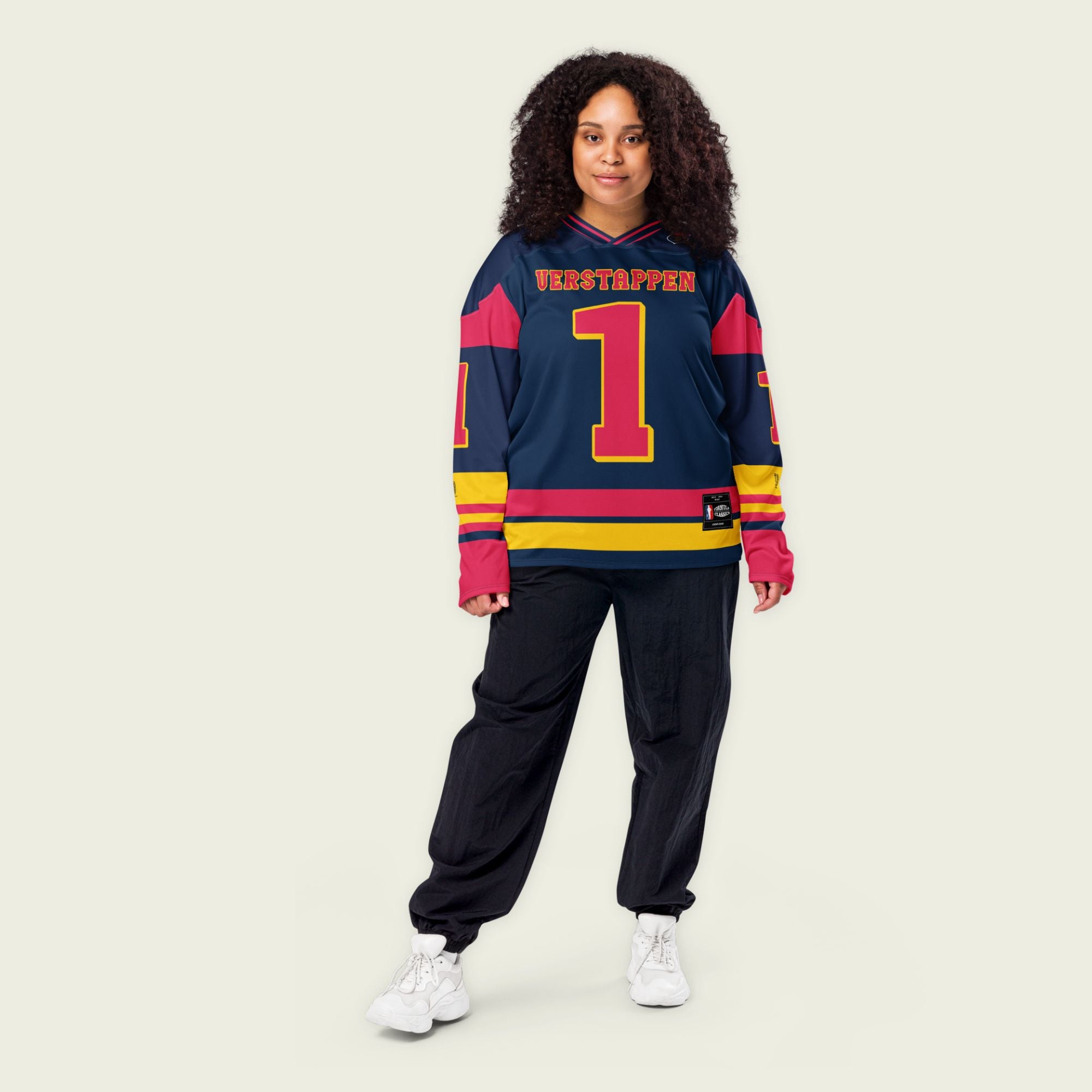 A navy blue hockey jersey with Max Verstappen's F1 racing number 1 in red on the front and back. It has the name Verstappen on the back and front in red as well.
