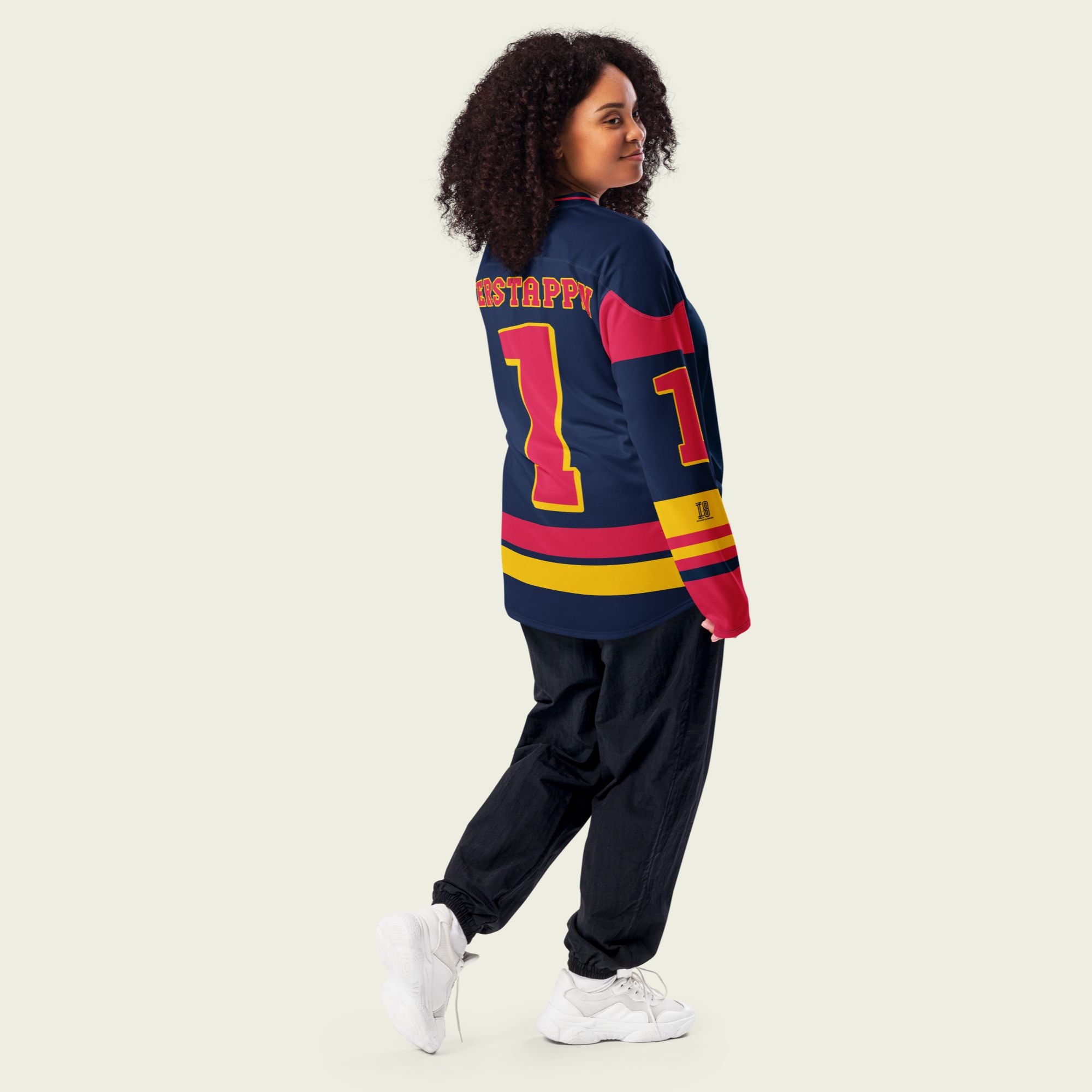 A navy blue hockey jersey with Max Verstappen's F1 racing number 1 in red on the front and back. It has the name Verstappen on the back and front in red as well.