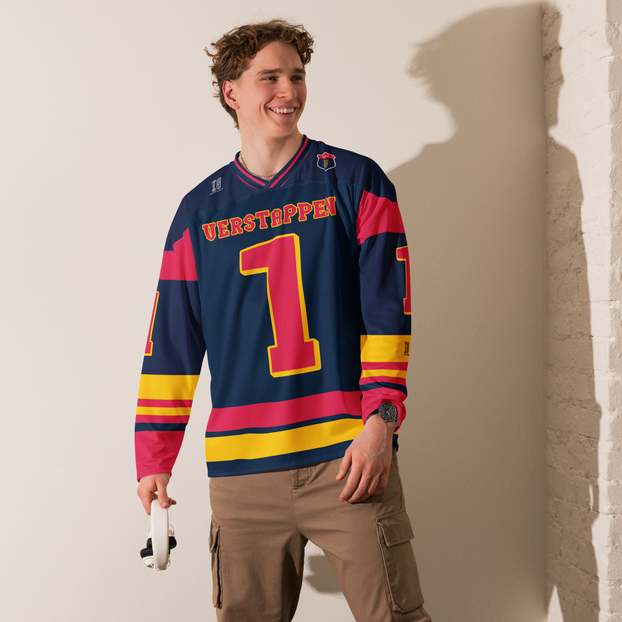 A navy blue hockey jersey with Max Verstappen's F1 racing number 1 in red on the front and back. It has the name Verstappen on the back and front in red as well.