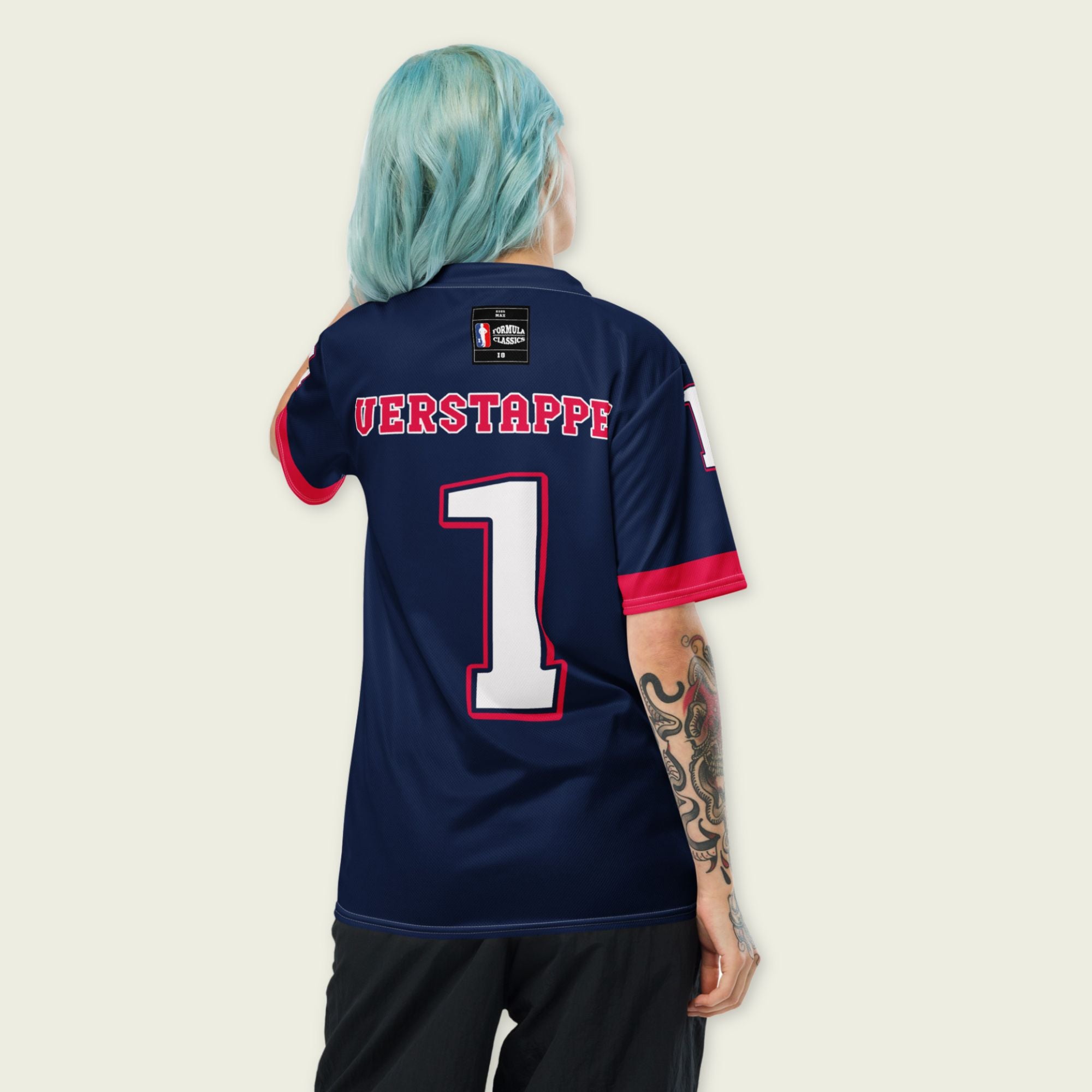 A navy blue and red football jersey with Max Verstappen's Redbull  F1 racing number 1 on the back and front in white. It has the name Verstappen in white on the front and back as well.