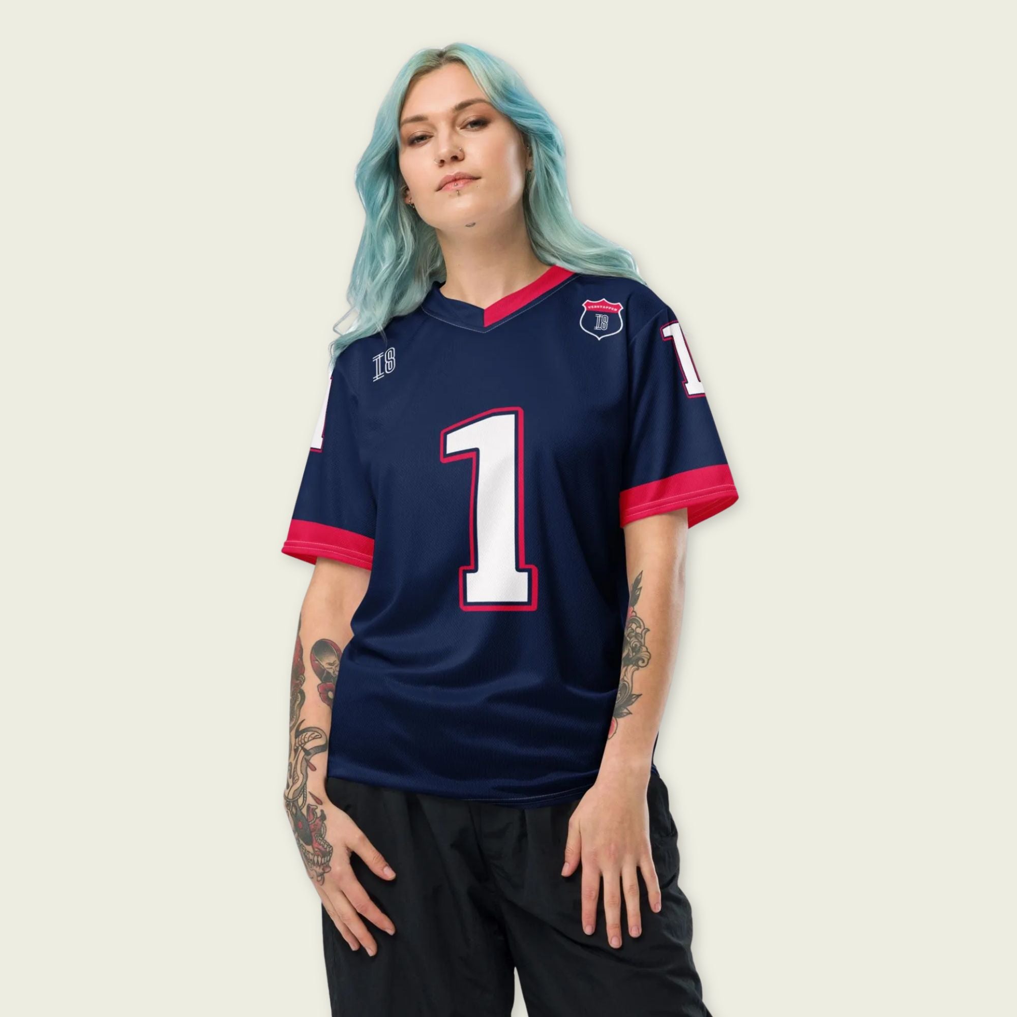 A navy blue and red football jersey with Max Verstappen's Redbull  F1 racing number 1 on the back and front in white. It has the name Verstappen in white on the front and back as well.