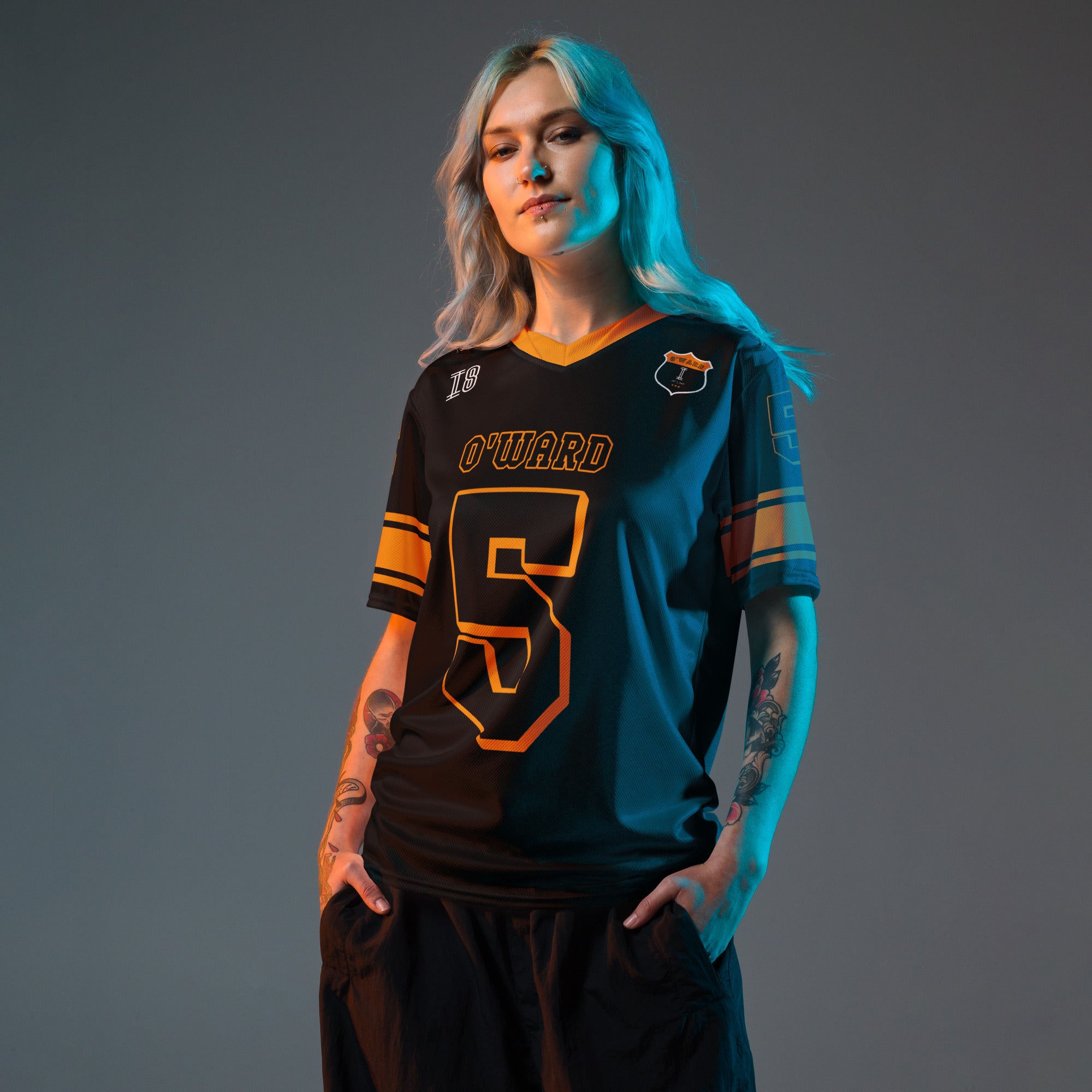 A black and orange football jersey with Pato O'Wards Arrow McLaren Indycar racing number 5 in orange. It has the name O'Ward on the front and back in orange as well.