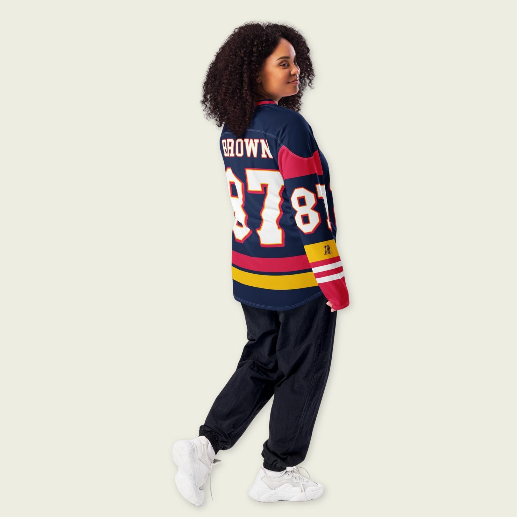 Person wearing a colorful sports jersey with 'Brown' and number '87' on a plain background