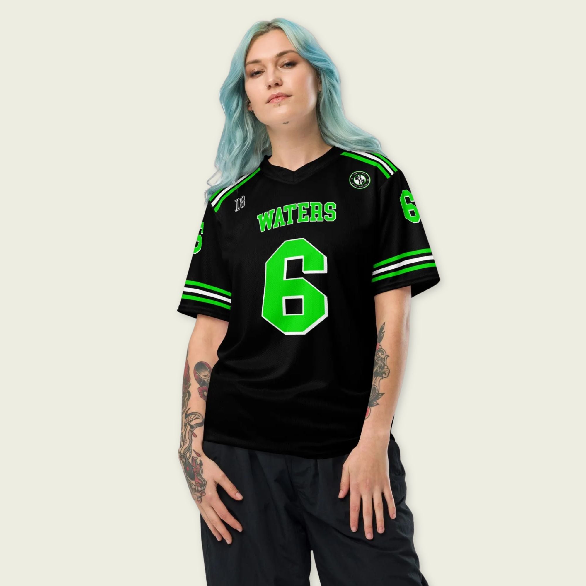 Person wearing a black sports jersey with green lettering and number on a plain background
