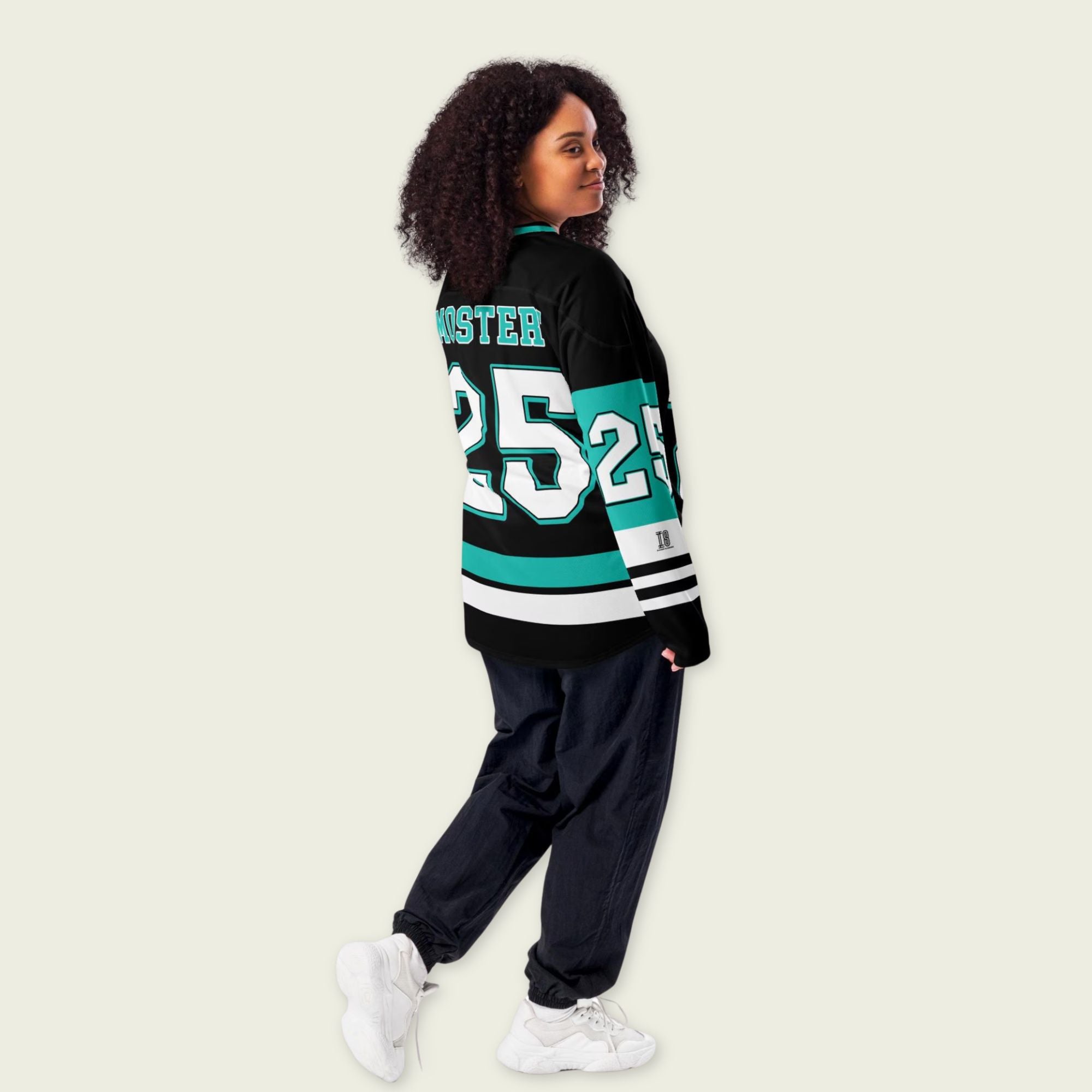 Person wearing a black and teal sports jersey with number 25 on a beige background