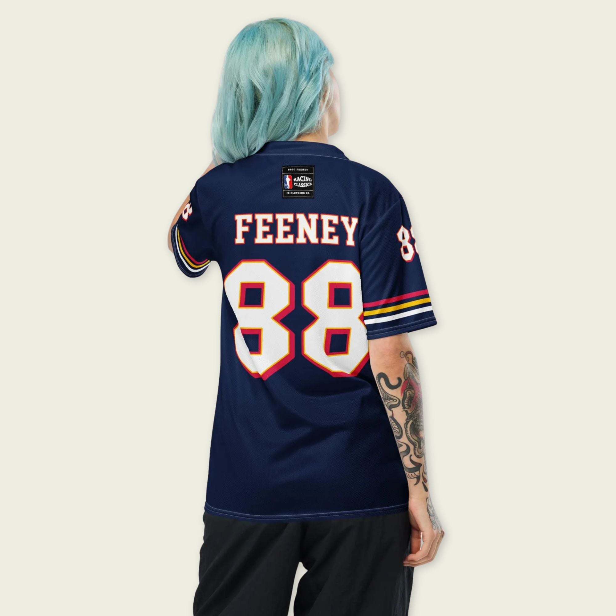 Person wearing a navy blue sports jersey with 'FEENEY' and number '88' on the back, against a light beige background.