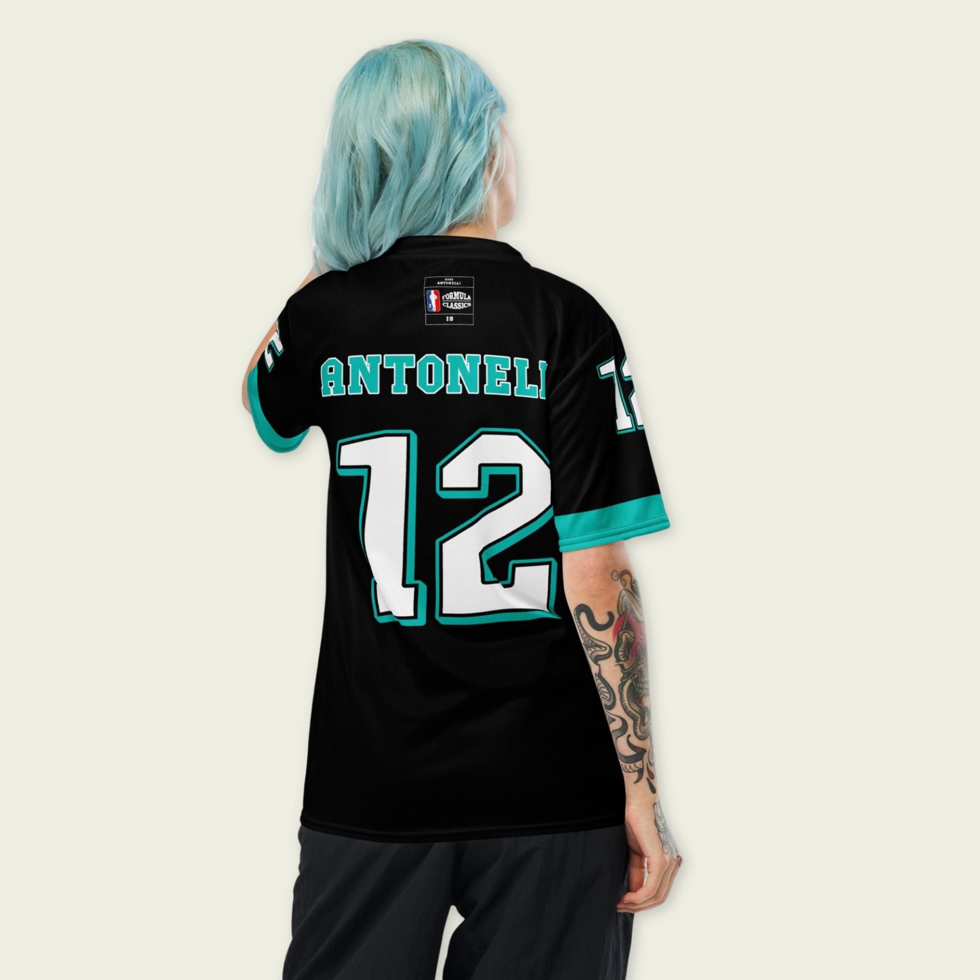 A black and AMG Green football jersey with Andrea Kimi Antonelli's Mercedes F1 racing number 12 on the back and front in white. It has the name Antonelli in green on the front and back as well.
