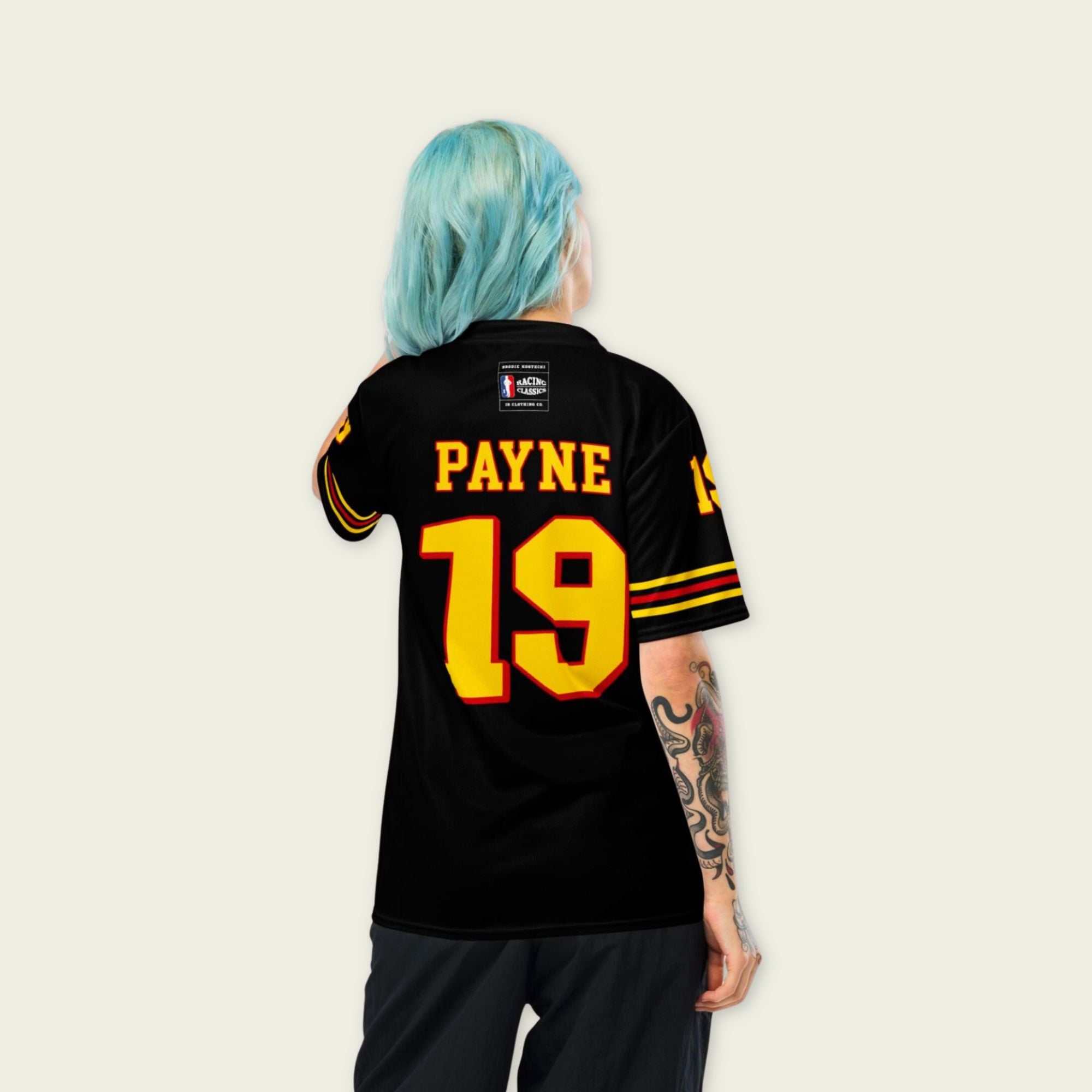 Person wearing a black sports jersey with yellow text and numbers on a plain background