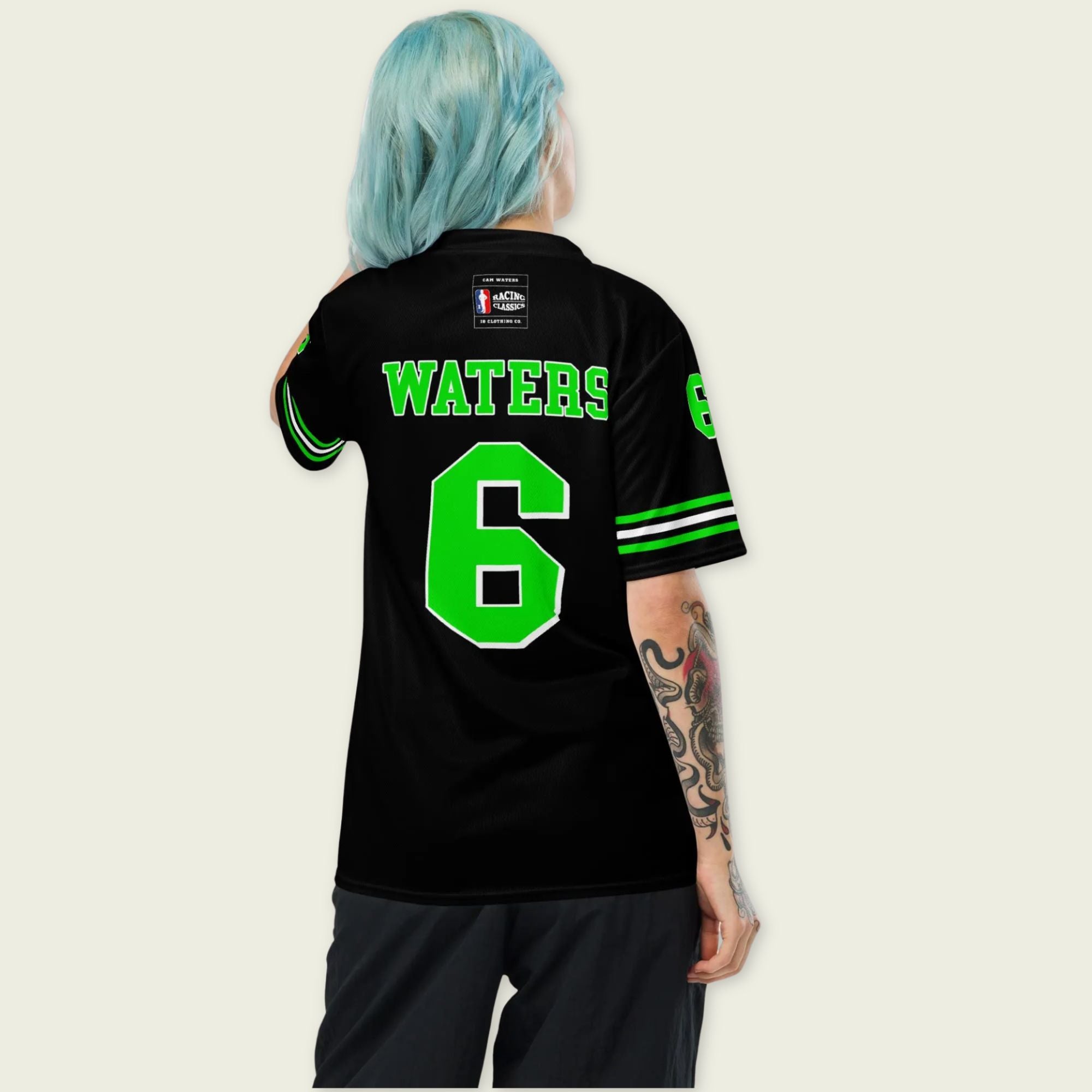 Person wearing a black sports jersey with green lettering and number on a plain background