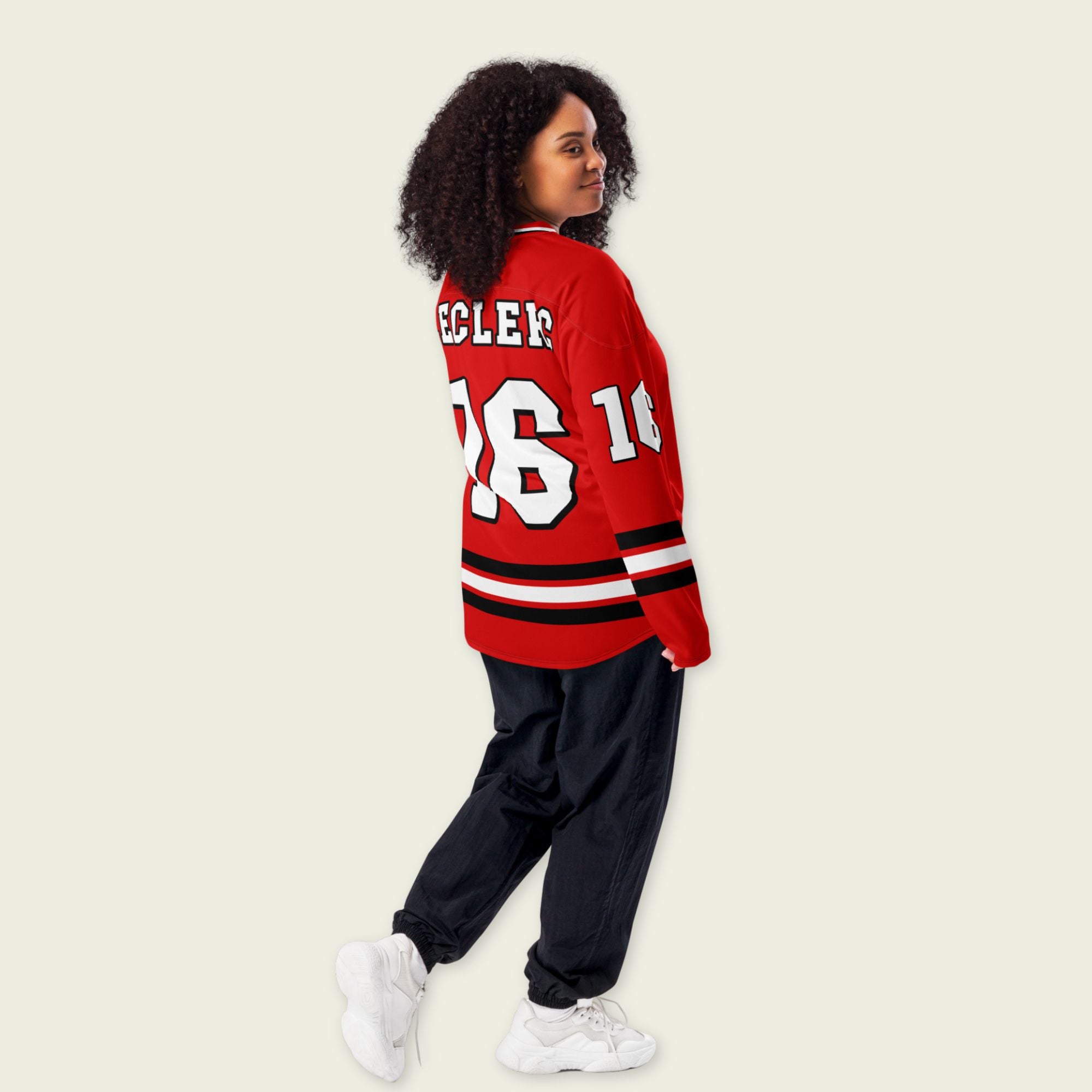 A Ferrari red hockey jersey with charles lecerc's f1 racing number 16 on the front in back, colored in black.