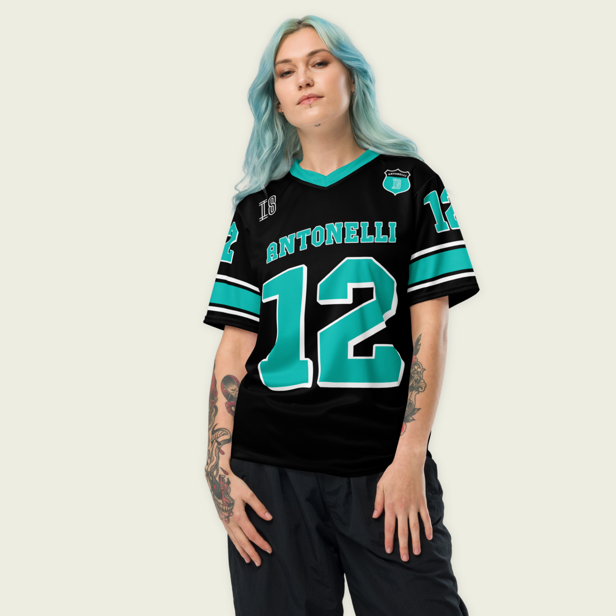 A black an turqoise colored football jersey with Kimi Antonelli's Mercedes F1 racing number 12 on the front and back