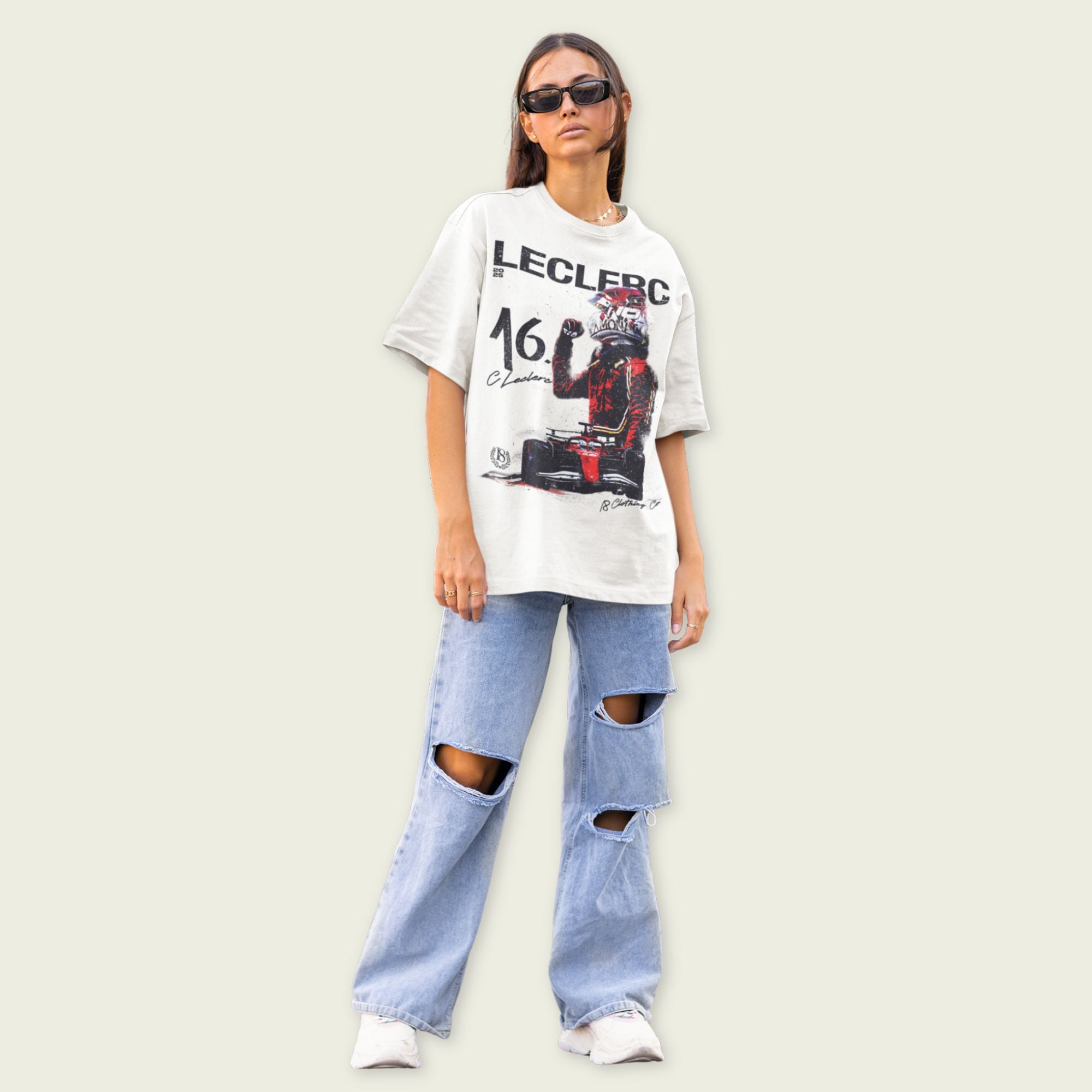 Person wearing a graphic t-shirt and ripped jeans on a plain background