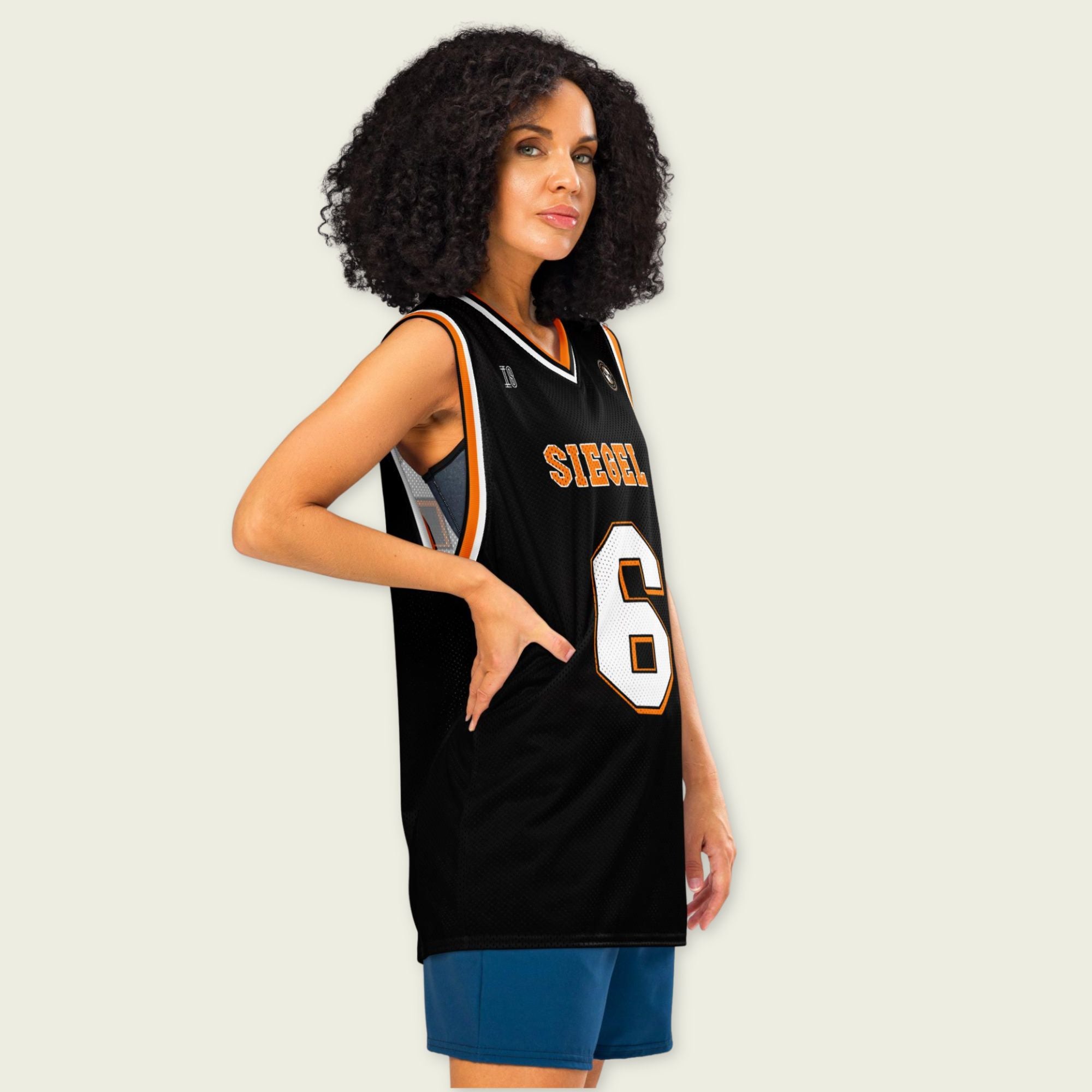 Woman wearing a black basketball jersey with 'Sierra' and number '6' on a plain background