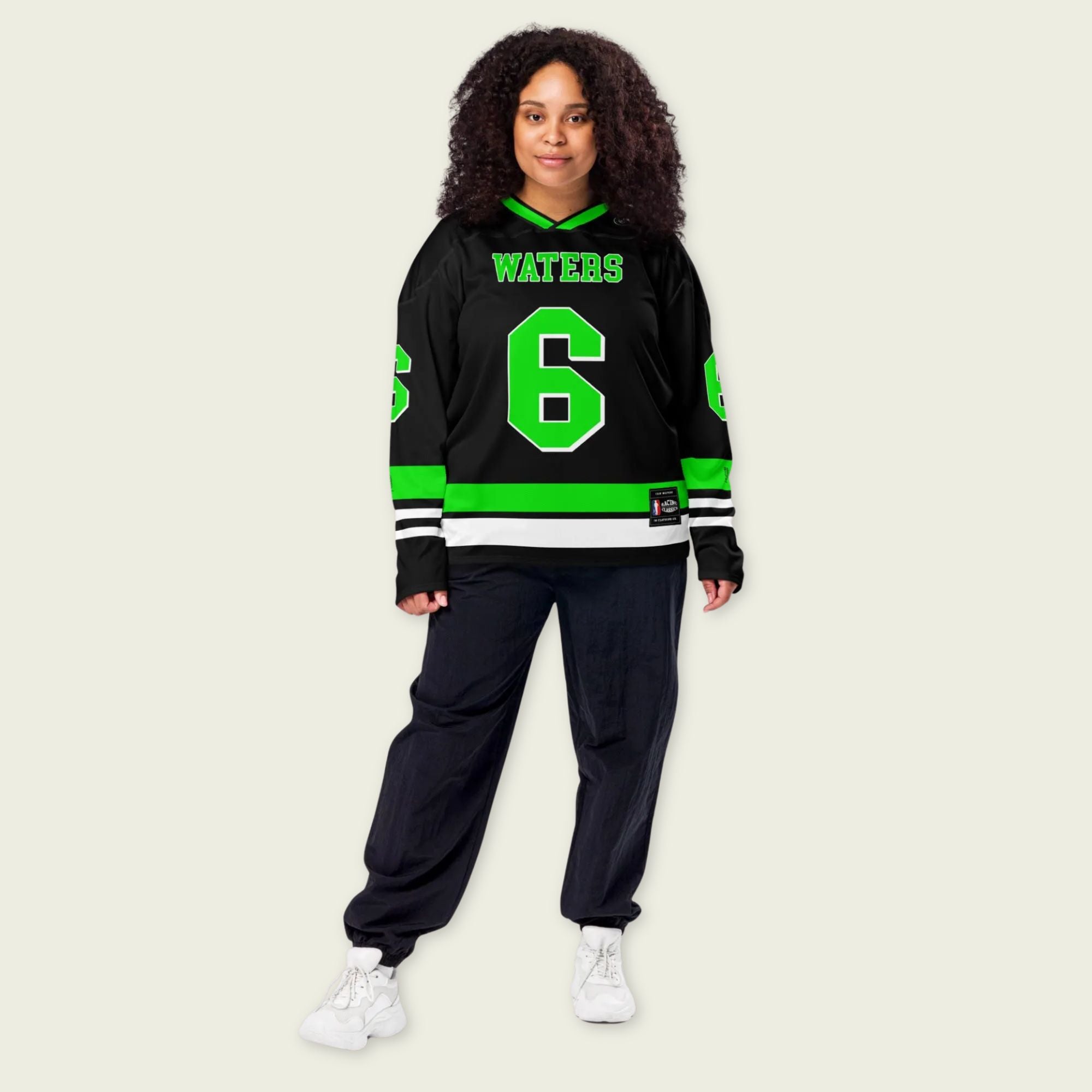 Person wearing a black and green sports jersey with the number 6 and name 'WATERS'.