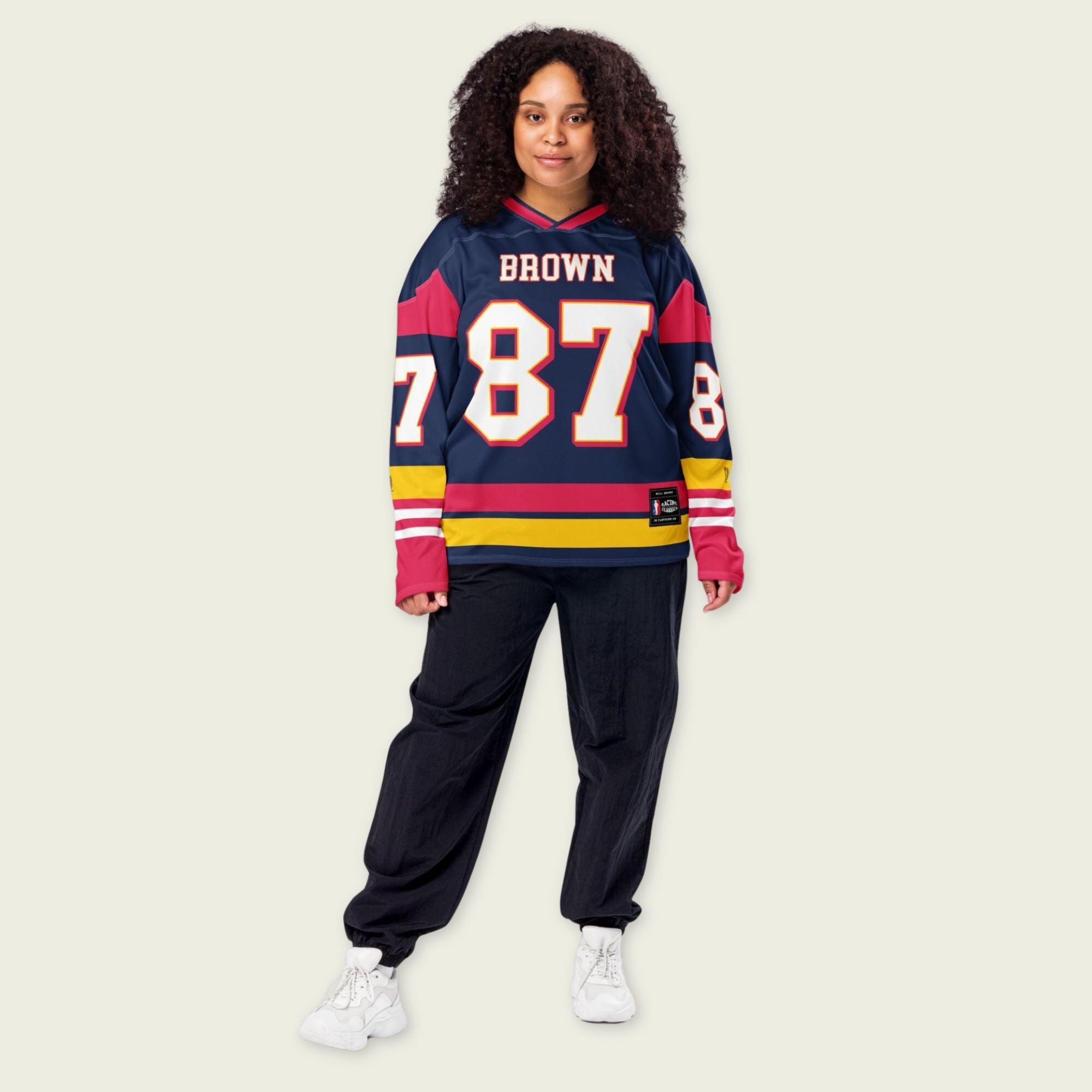 Person wearing a sports jersey with the name 'Brown' and number '87' on a plain background