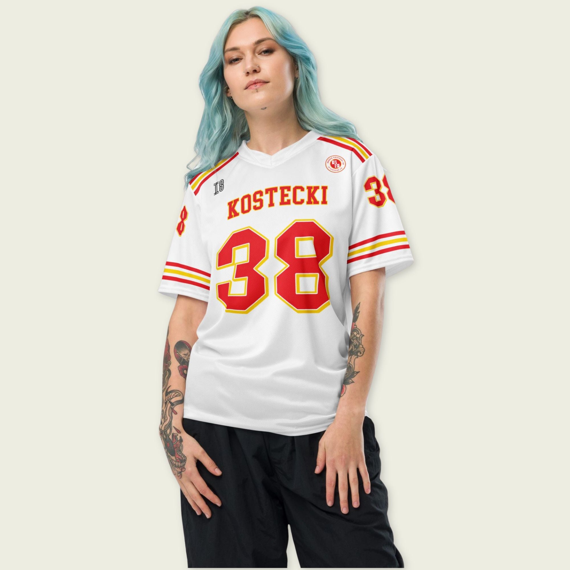 Person wearing a white sports jersey with red and yellow text and numbers on a plain background