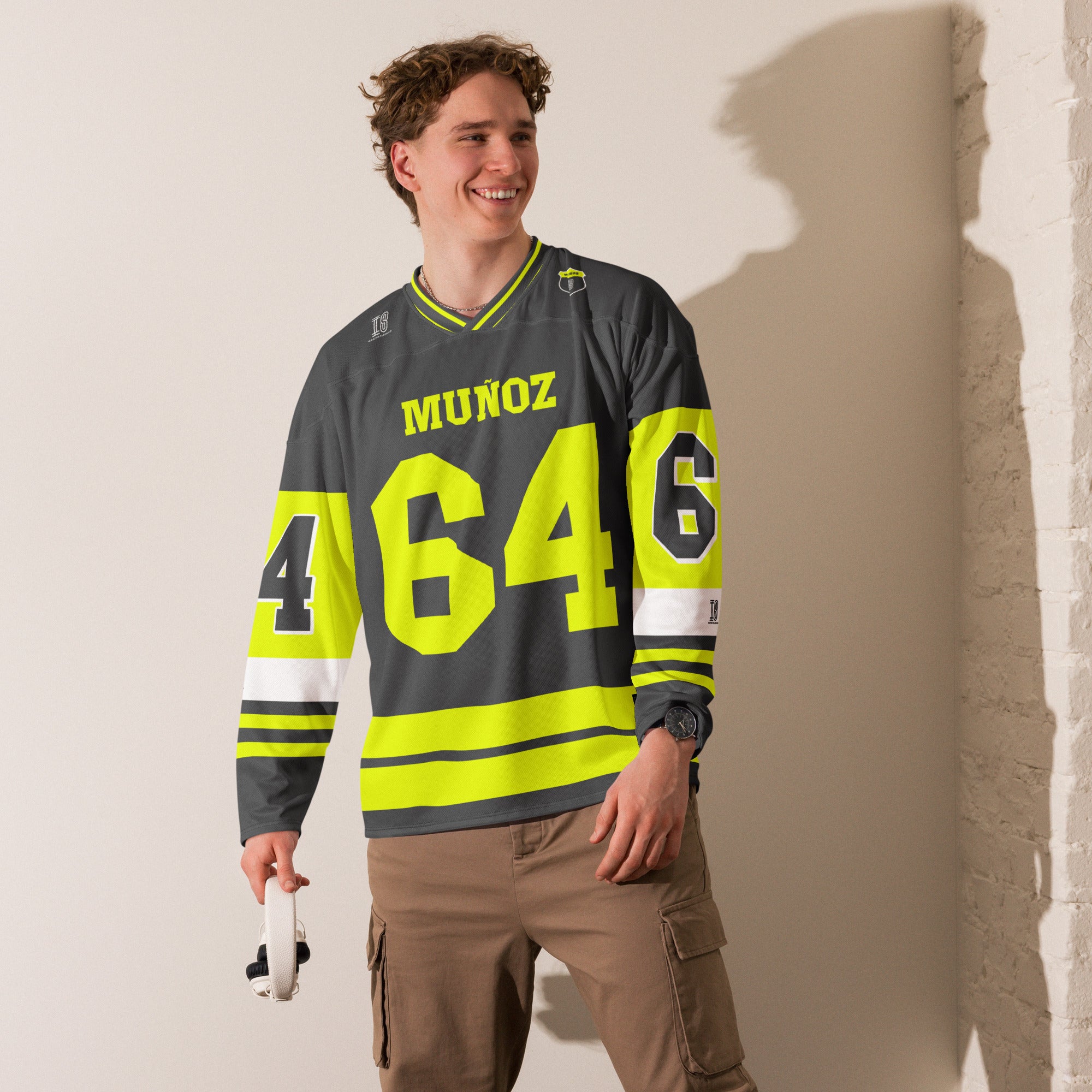A Grey and highlight yellow hockey jersey with Daivd Munuzs name and moto gp racing number 64 on the front and back in yellow.