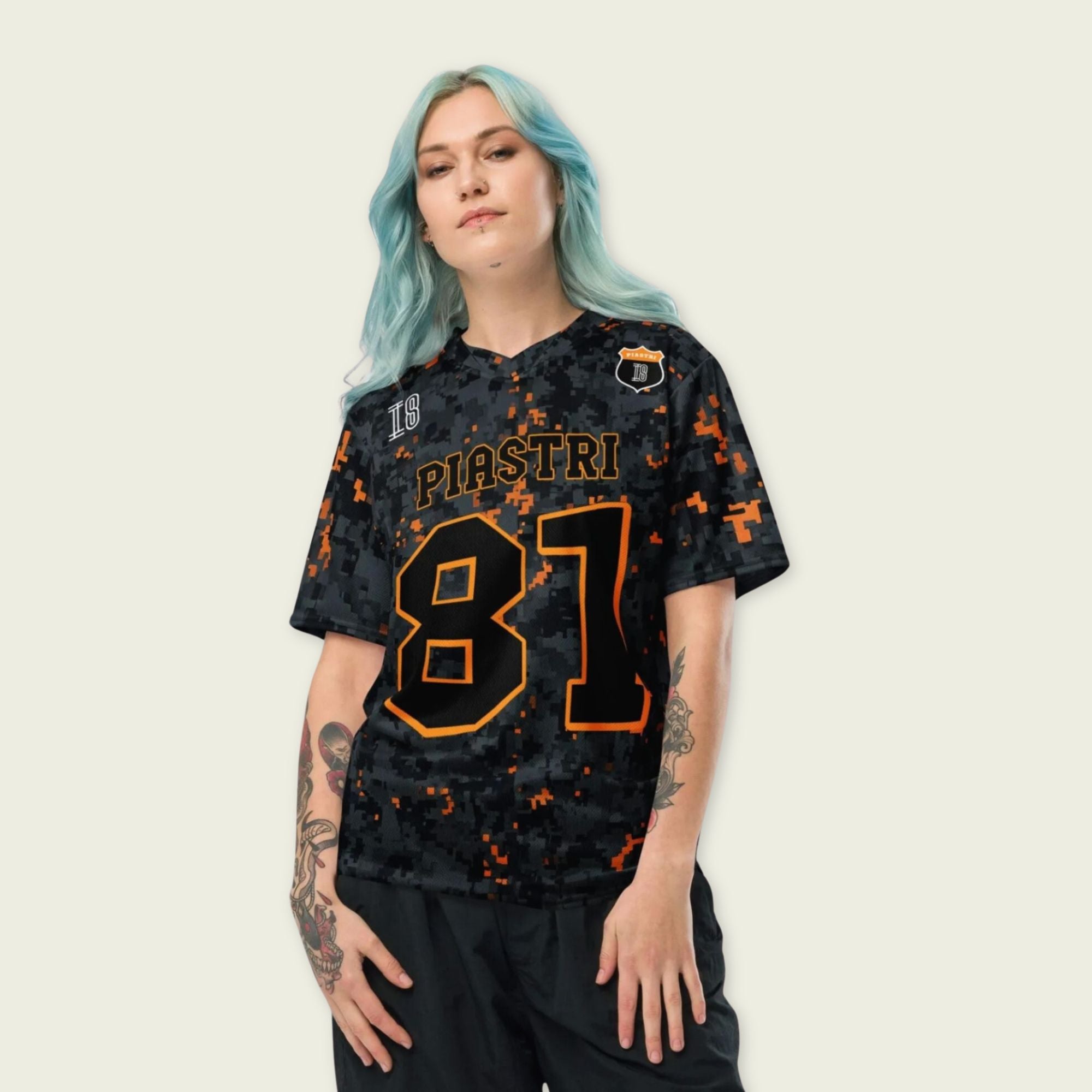 A camoflauge papaya orange football jersey with LOscar Piastri's McLaren F1 Racing number 81 on the front and back.