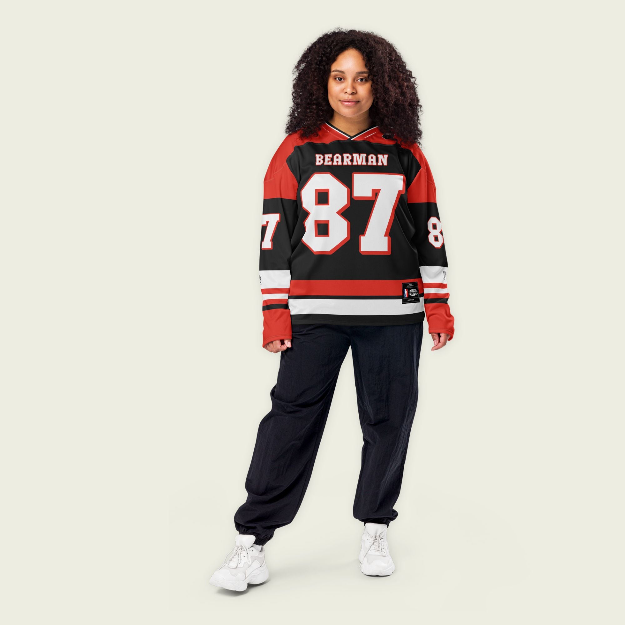 A red and black hockey jersey with Oliver Bearman's Haas F1 racing number 87 on the front and back in white, also the name Bearman is on the back and front in White.
