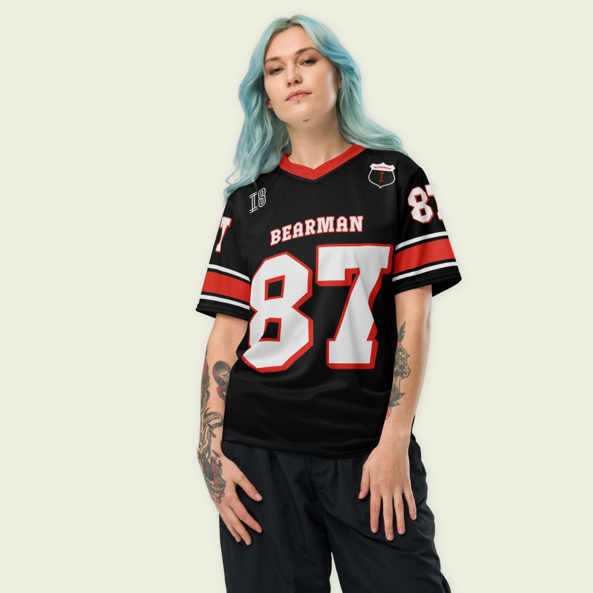 A black and red football jersey with Oliver Bearman's Haas F1 Racing number 87 in white on the front and back.