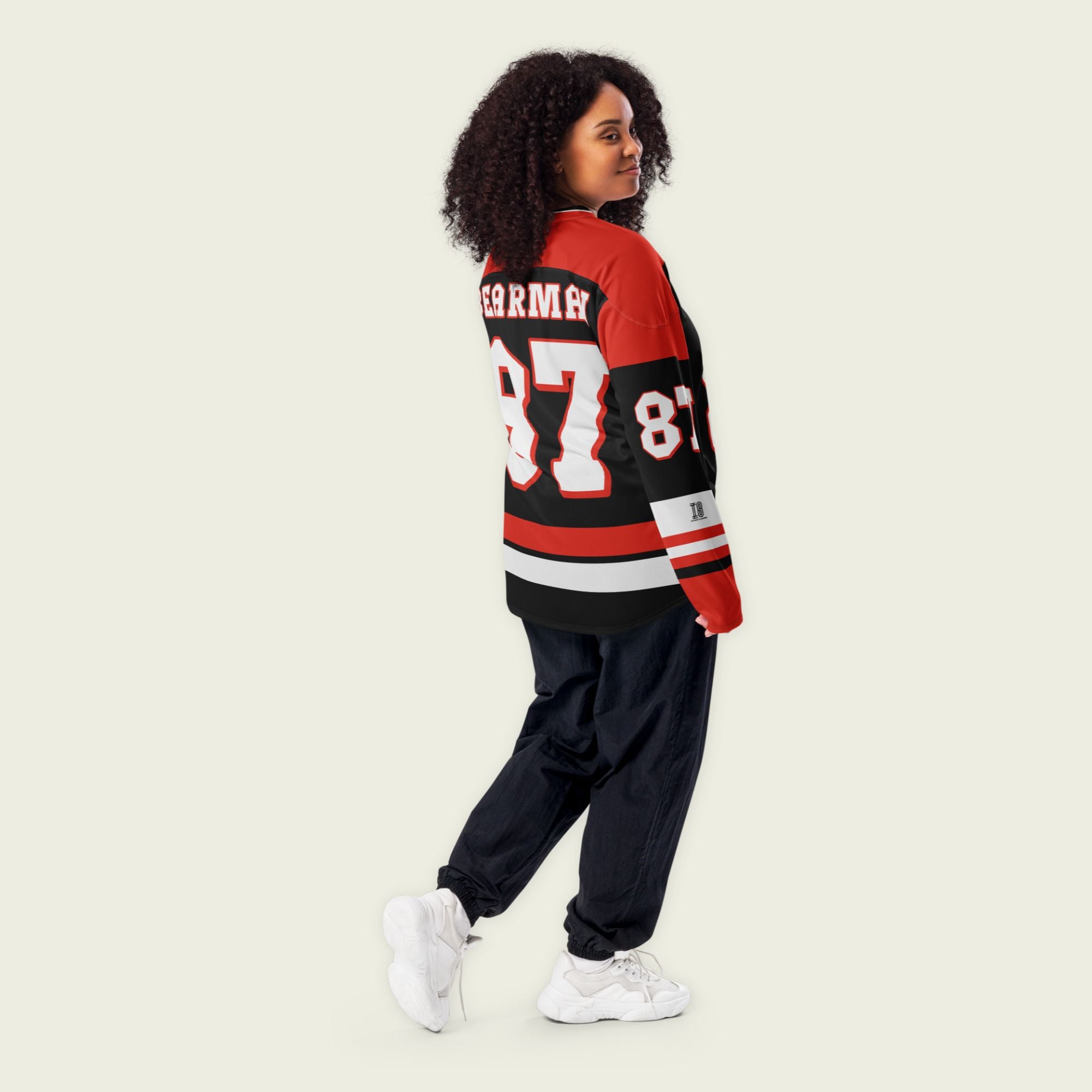 A red and black hockey jersey with Oliver Bearman's Haas F1 racing number 87 on the front and back in white, also the name Bearman is on the back and front in White.