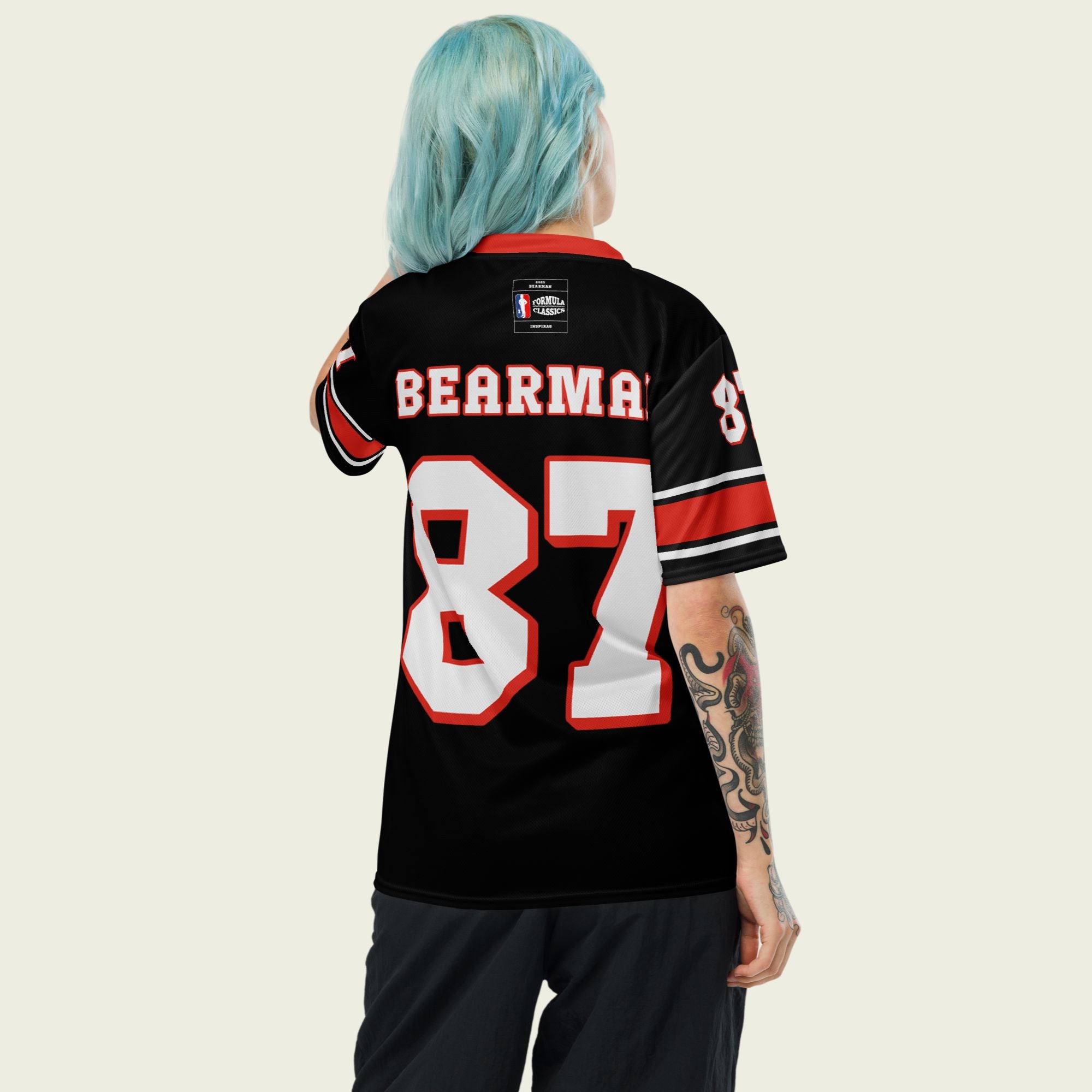 A black and red football jersey with Oliver Bearman's Haas F1 Racing number 87 in white on the front and back.