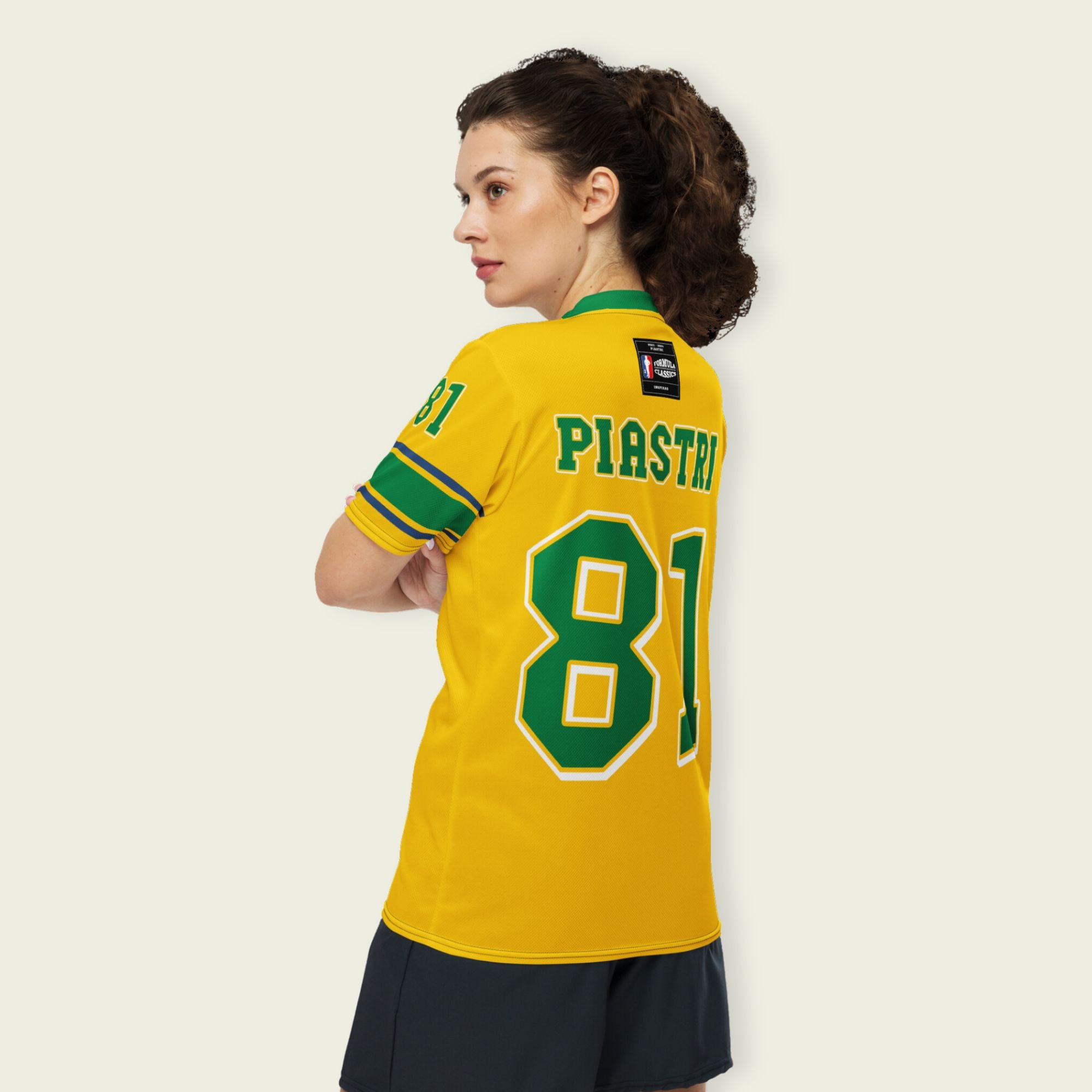 A Aussie green and gold football jersey with Oscar Piastri's McLaren  F1 racing number 81 on the back and front in green with a white outline.