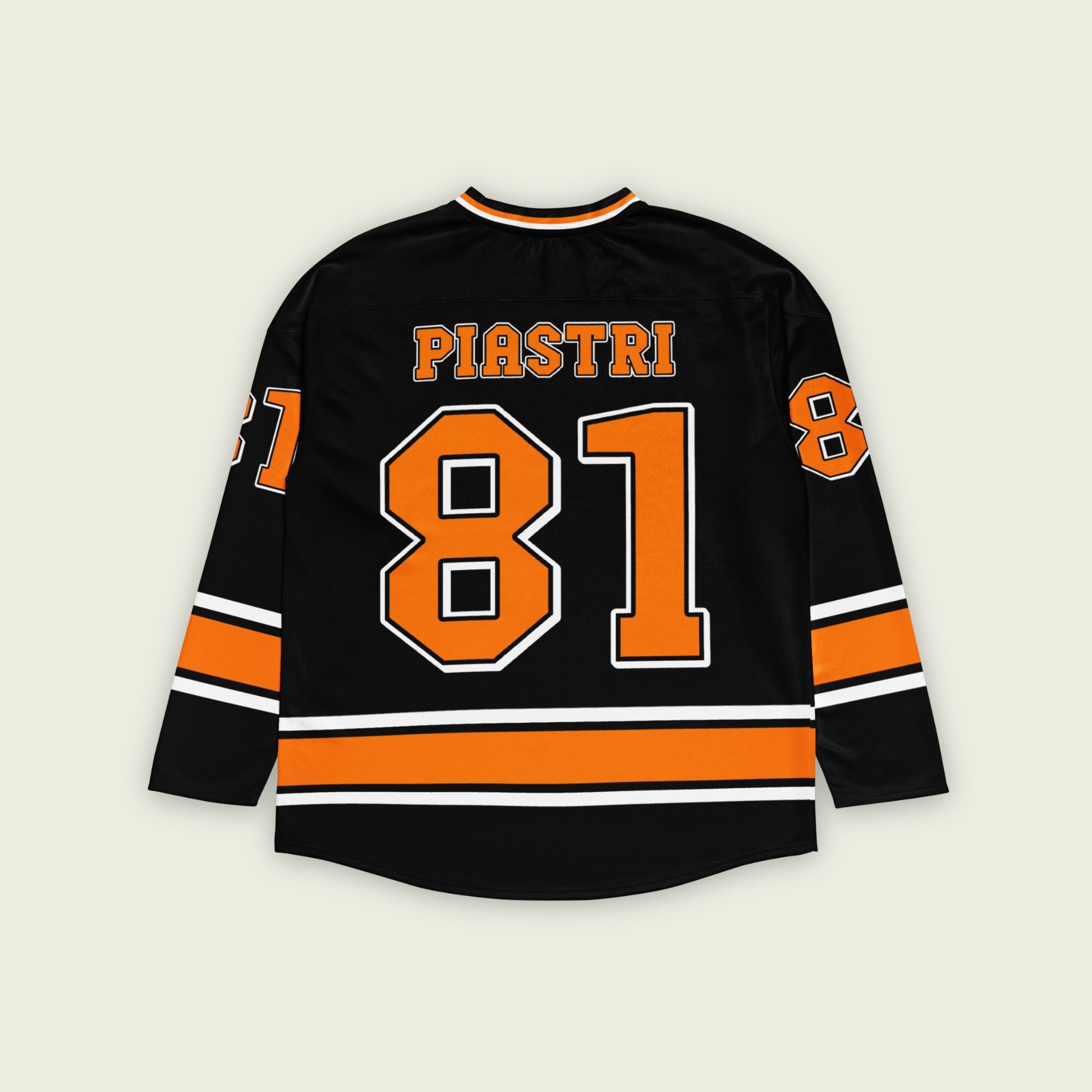 A black hockey jersey with Oscars piastri's McLaren F1 racing number 81 on the front and back in papaya orange, also the name Piastri is on the back in orange