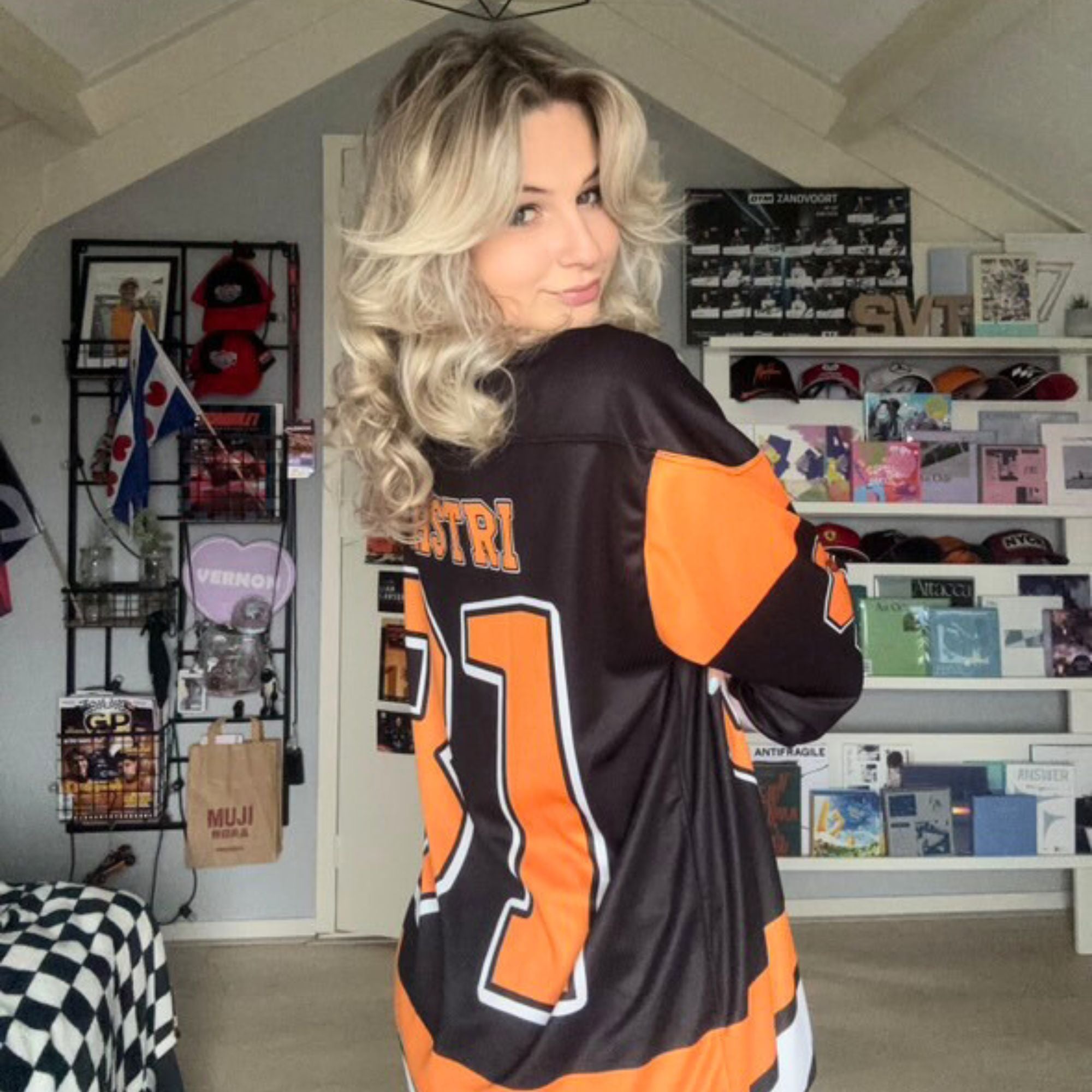 A black hockey jersey with Osacr Piastri's mclaren F1 racing number 81 on the front and back in papaya orange, also the name norris is on the back and front in orange