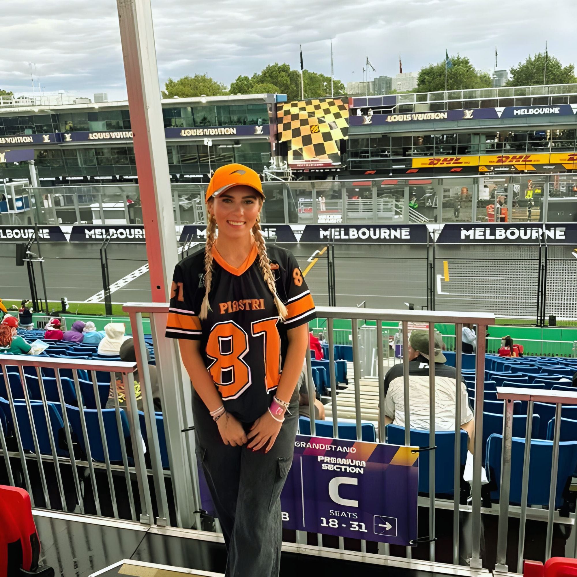 A black and papaya orange football jersey with Oscar Piastri McLaren F1 Racing number 81 in papaya orange on the front and back. The name Piastri is in orange on the front and back.