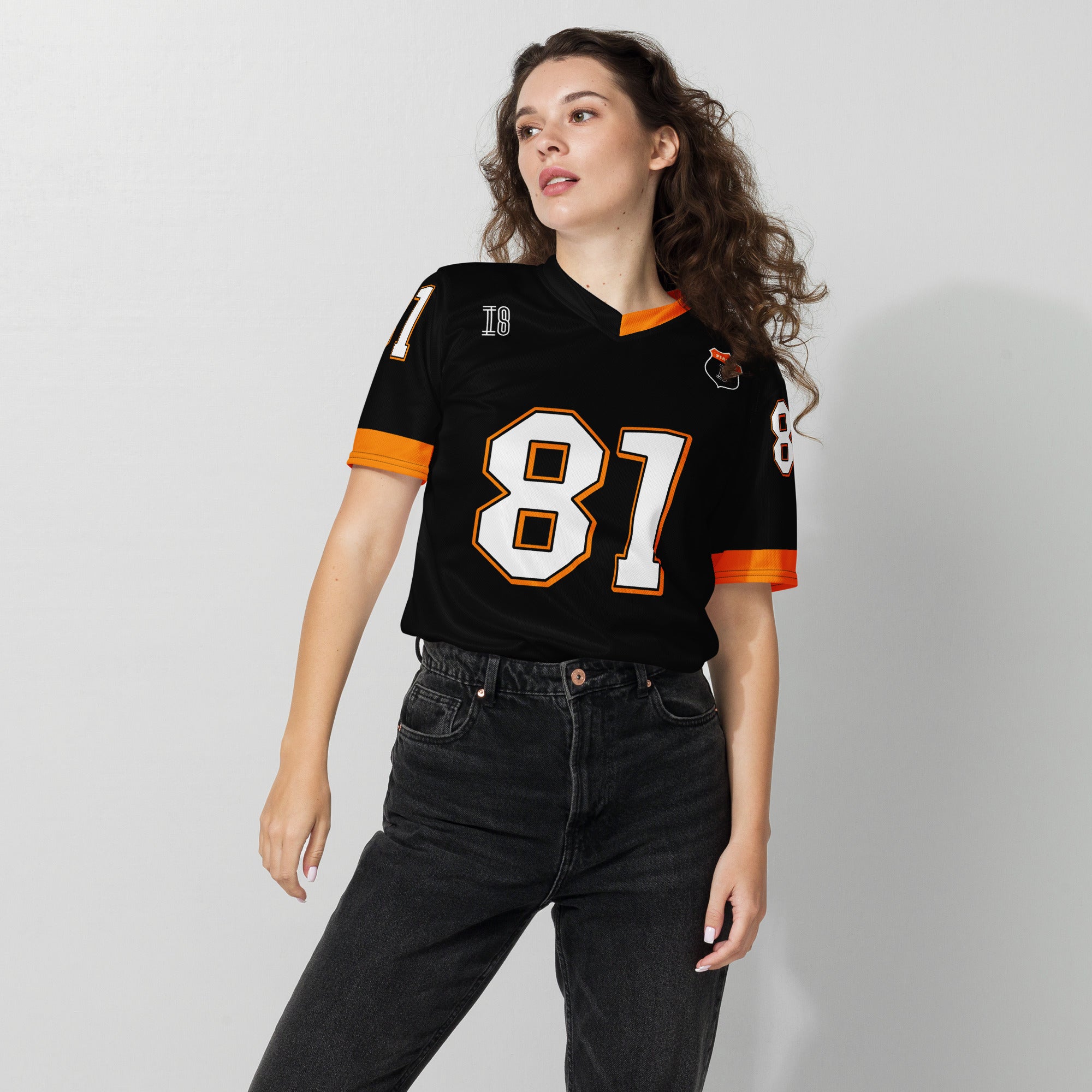 A black and papaya orange football jersey with Oscar Piastri's McLaren F1 racing number 81 on the back and front in white. It has the name Piastri in orange on the front as well.
