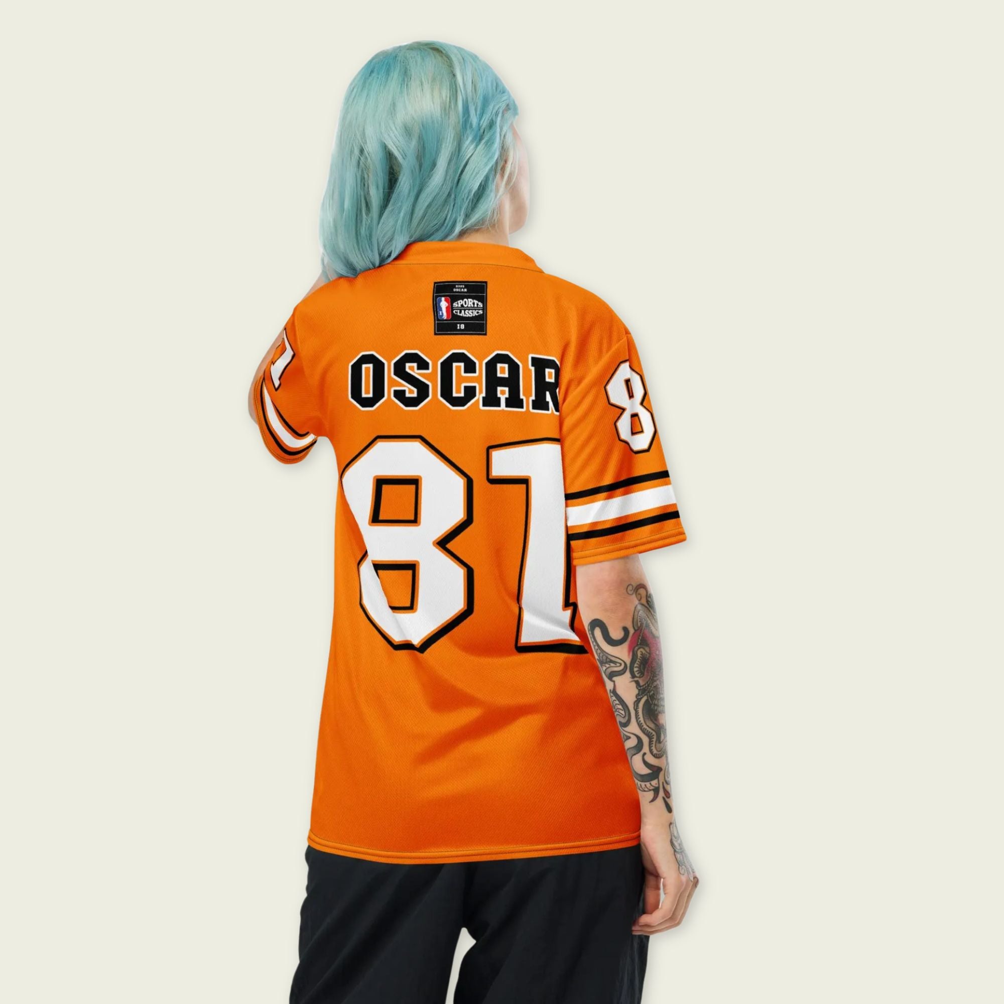 A papaya orange football jersey with Oscar Piastris McLaren  F1 Racing number 81 on the front and back.