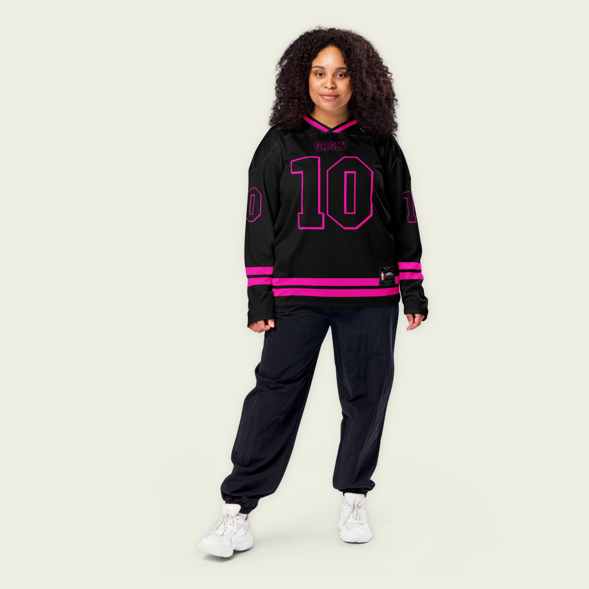 A black hockey jersey with two pink lines at the bottom both on the front and back. here is a pink number 10 that pierre gasly races in F1 on the fornt and back and his name Gasly on the front and back