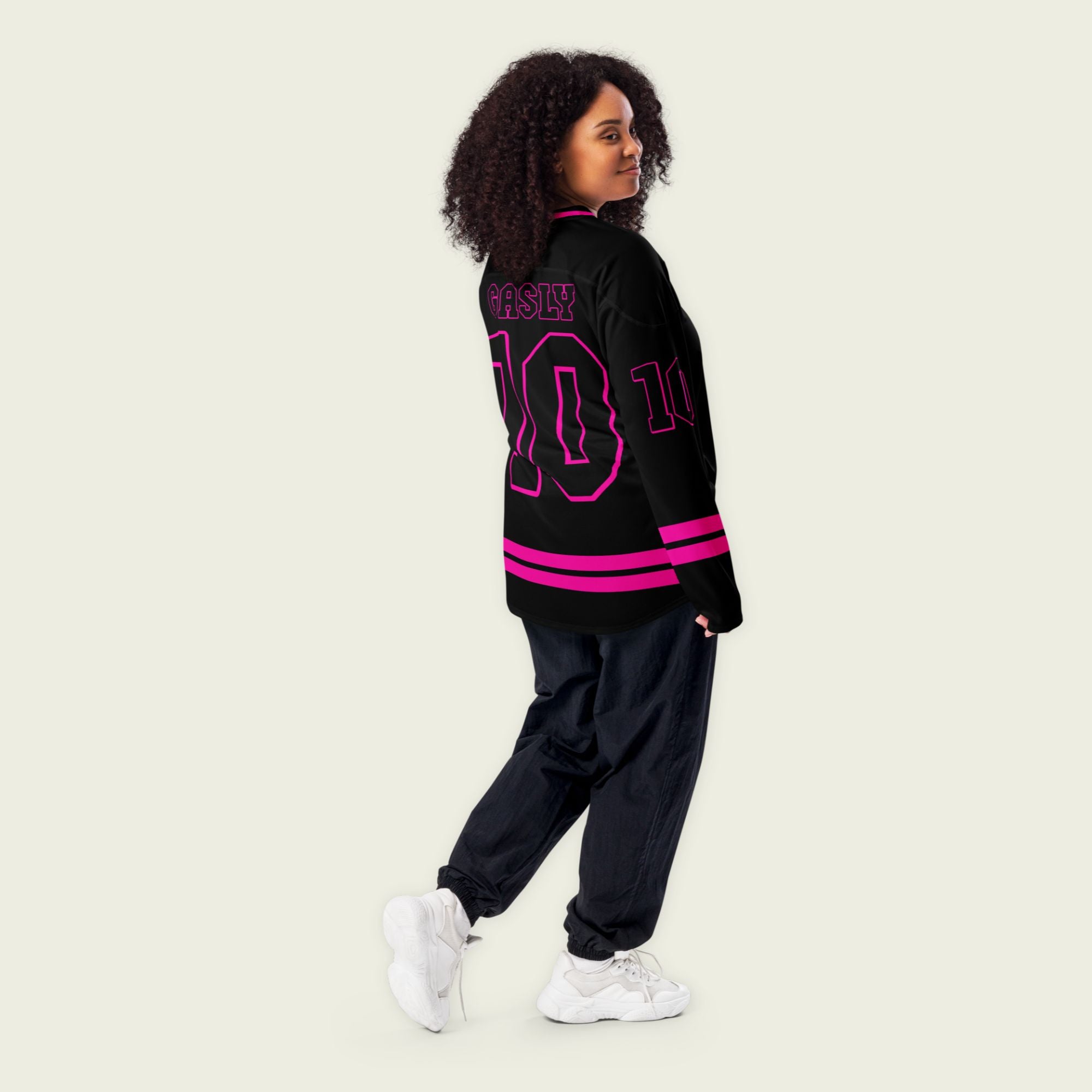 A black hockey jersey with two pink lines at the bottom both on the front and back. here is a pink number 10 that pierre gasly races in F1 on the fornt and back and his name Gasly on the front and back