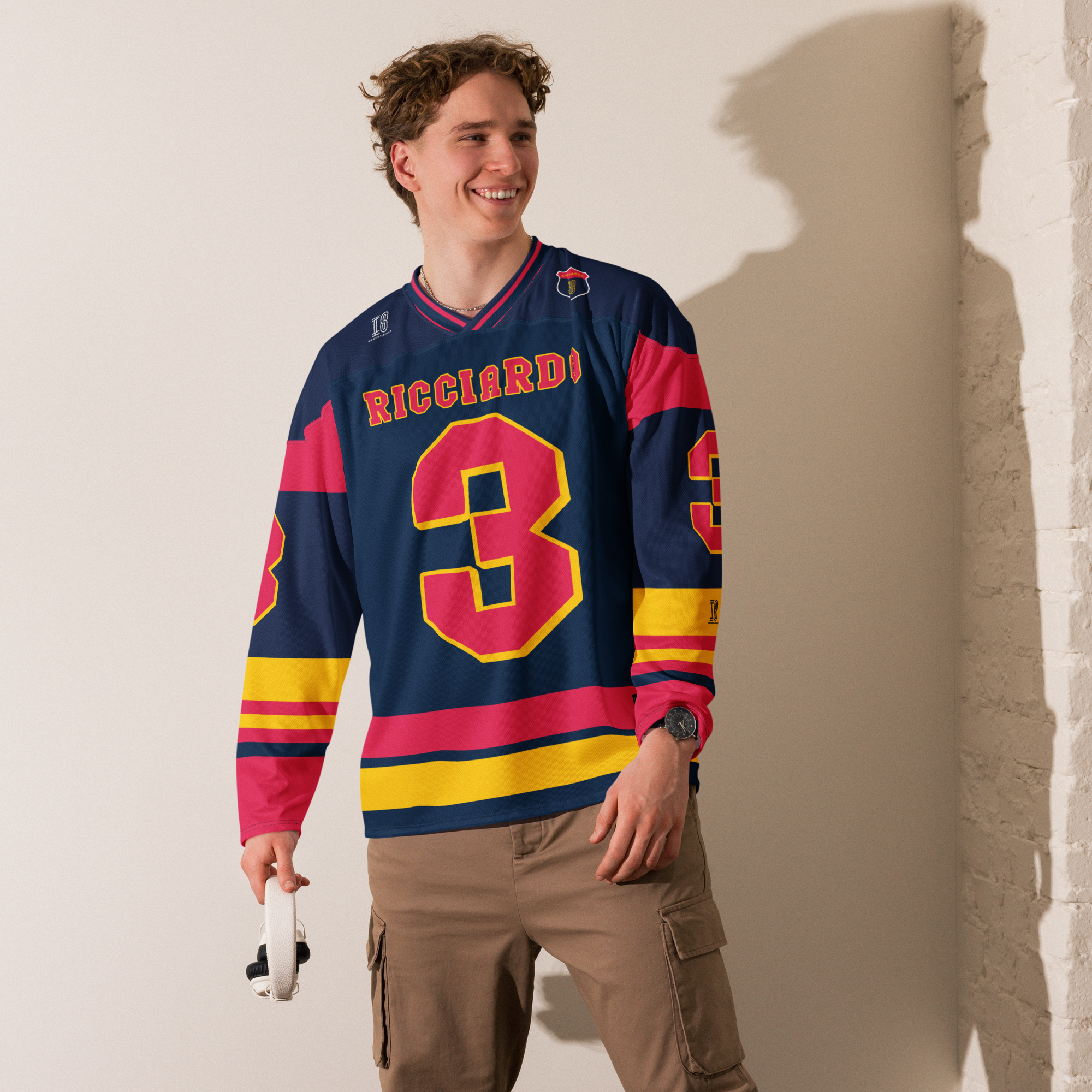 A navy blue hockey jersey with Daniel Ricciardo's Redbull F1 racing number 3 in red on the front and back. It has the name Ricciardo on the back and front in red as well.