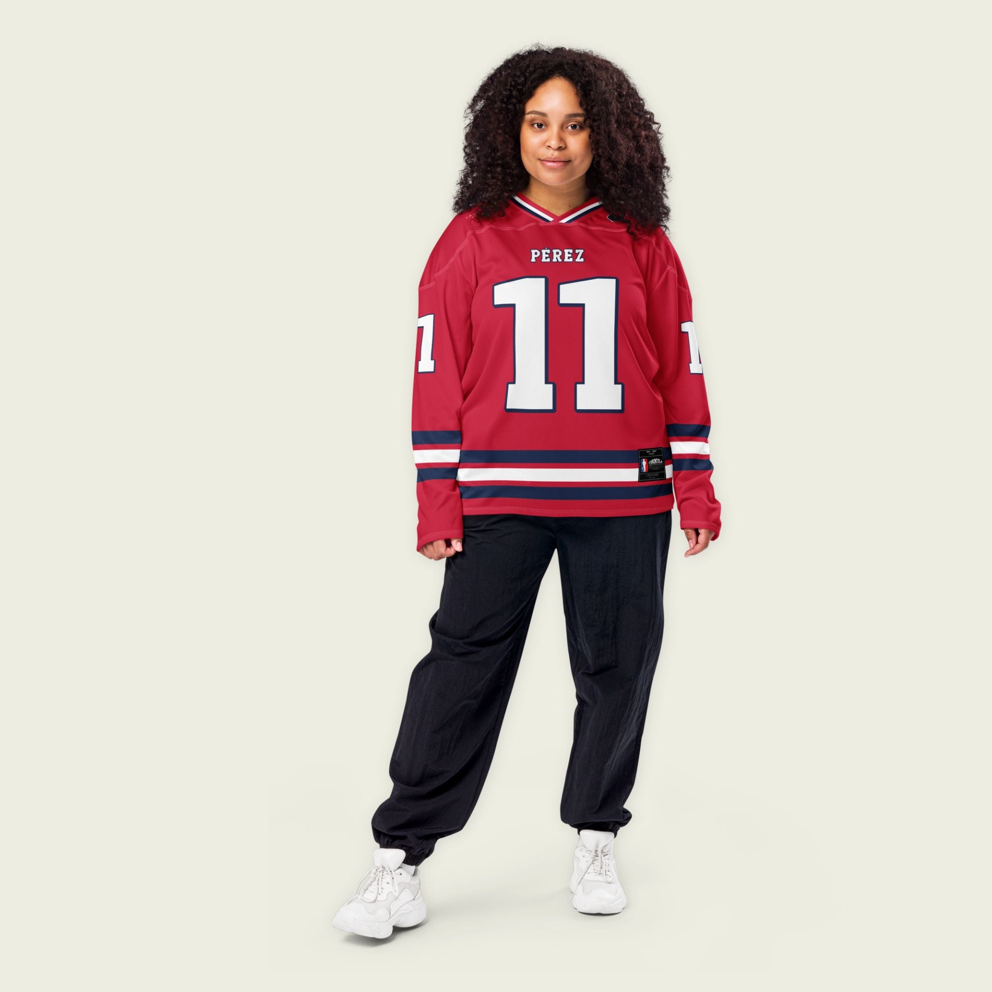 A red hockey jersey with Sergio Perez's Rebull F1 racing number 11 on the front and back in white, also the name Perez is on the back and front in white.