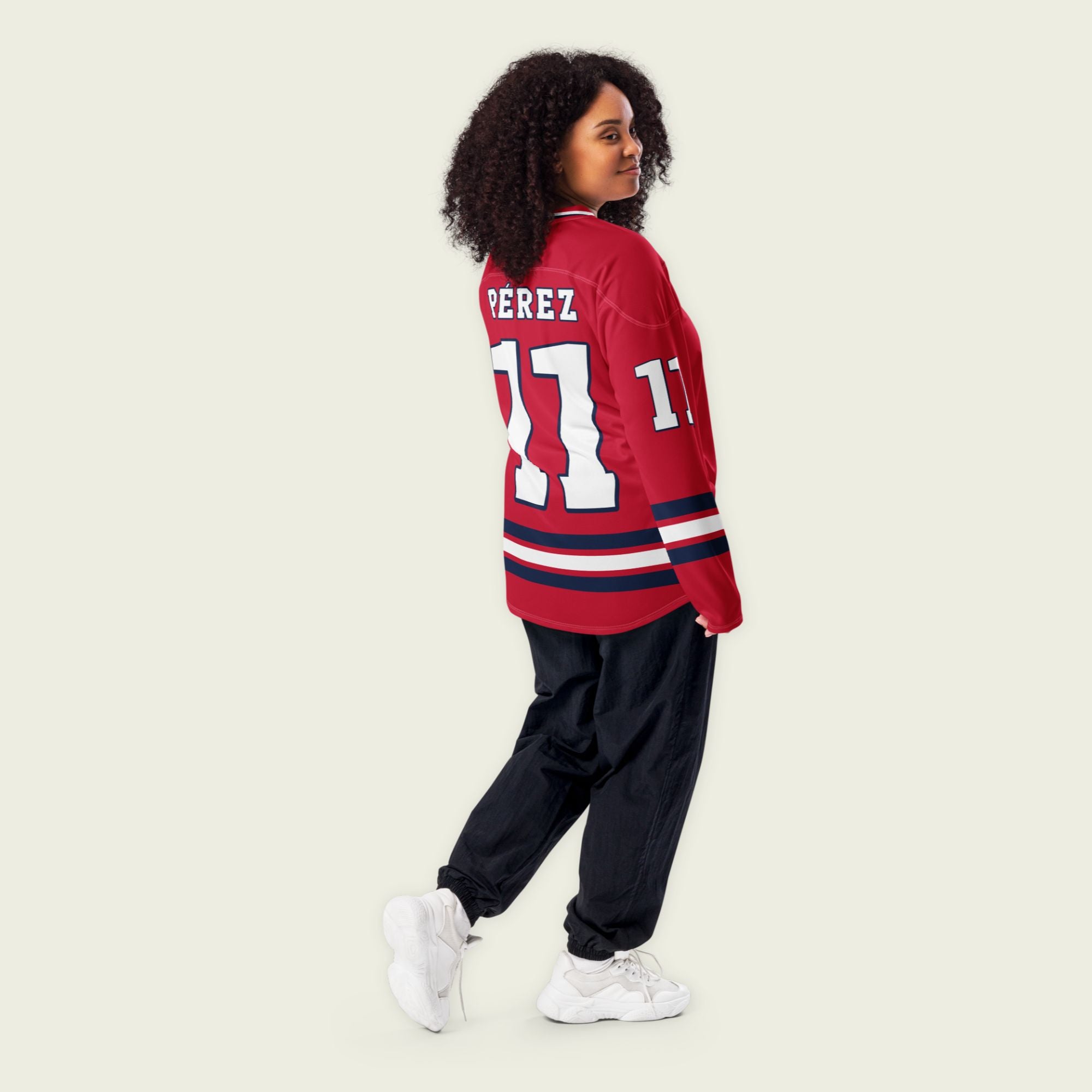 A red hockey jersey with Sergio Perez's Rebull F1 racing number 11 on the front and back in white, also the name Perez is on the back and front in white.