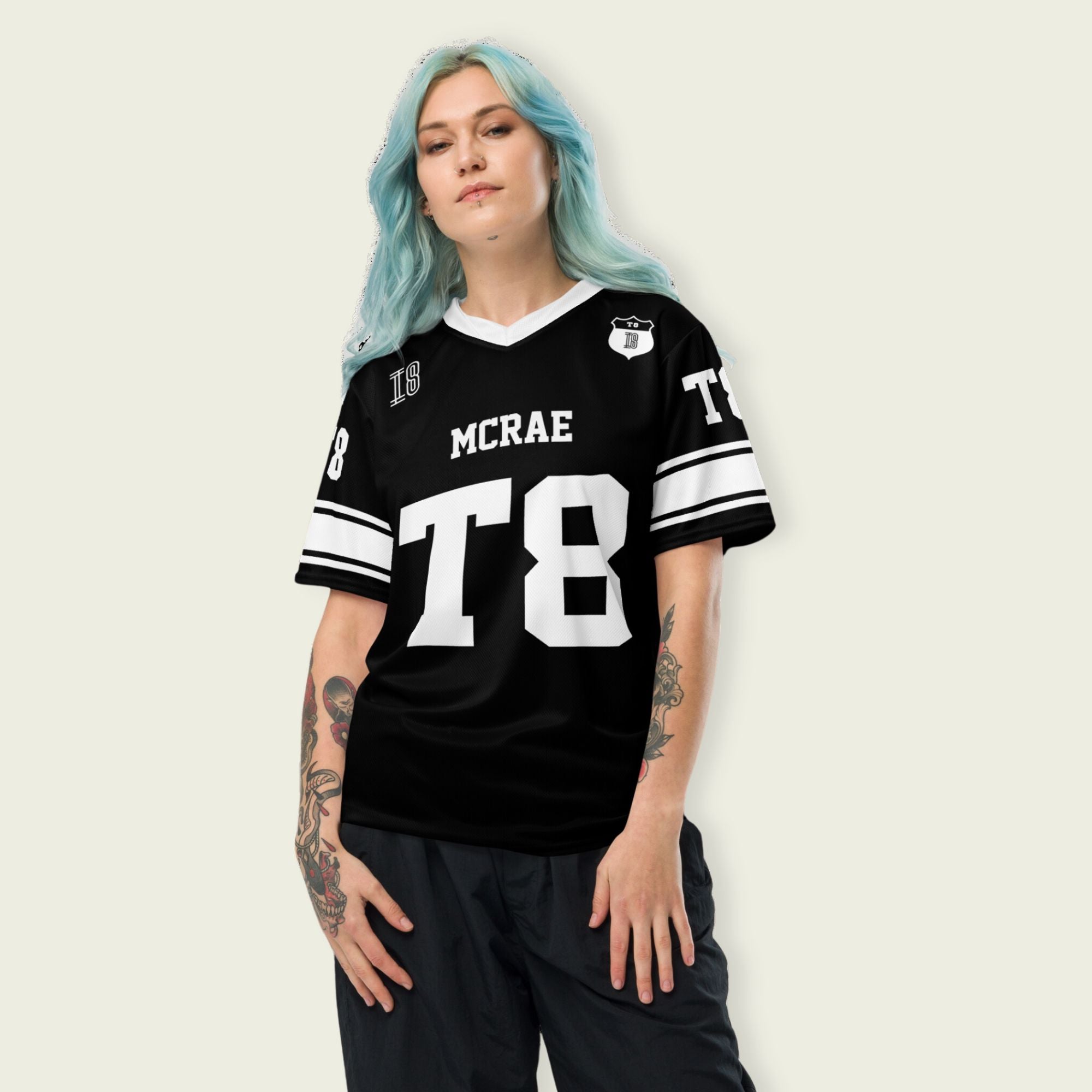 A black and white football jersey with Tate Mcare on the back and front in white with a white outline.