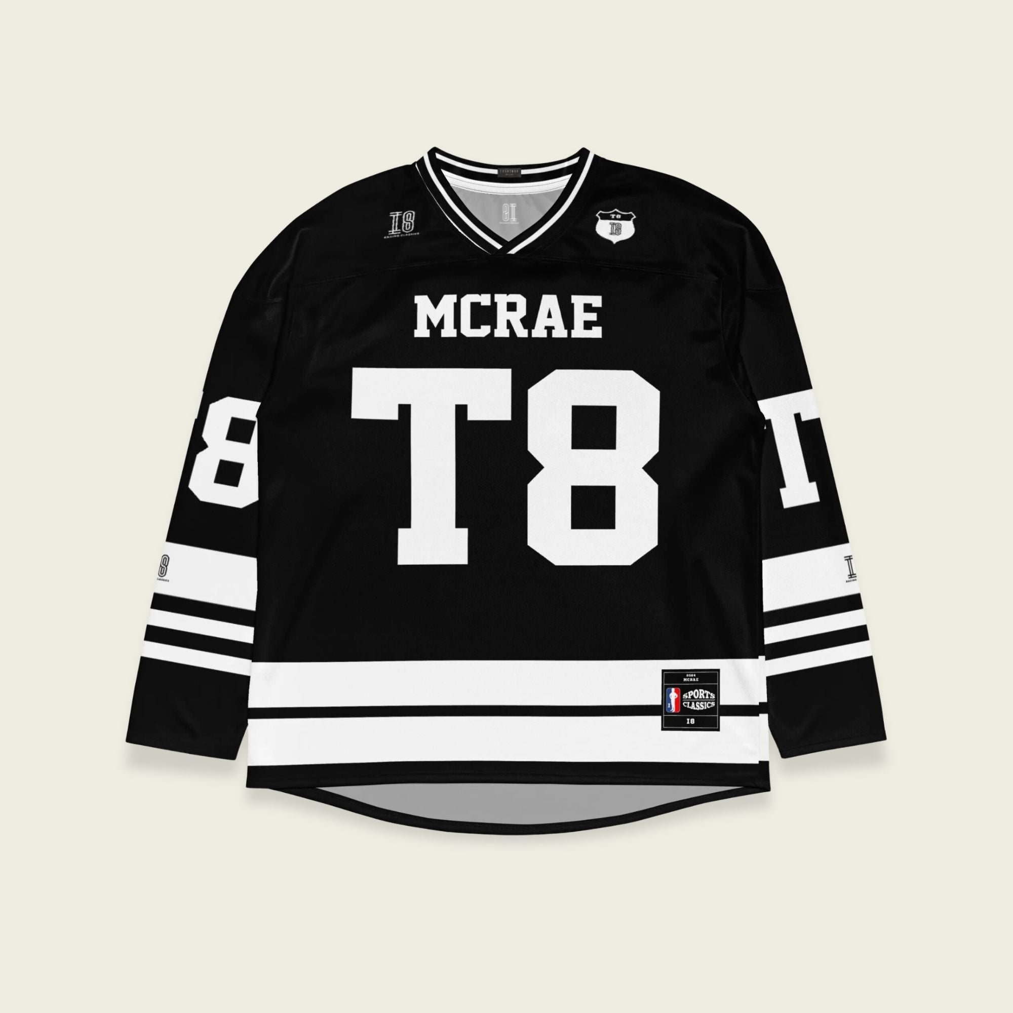 A black and white hockey jersey with the name Mcrae in white on the front and back. Also T8 in white on the front and back.